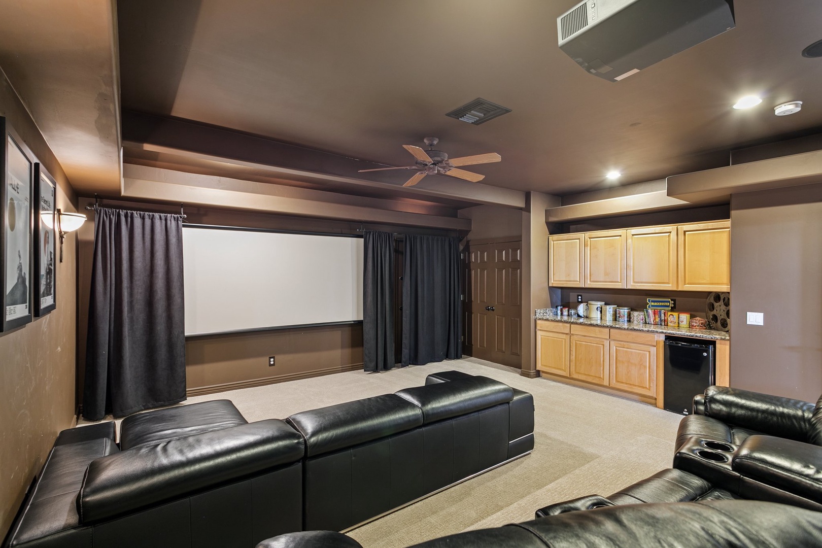 Your private theater awaits with plush leather recliners and a full kitchenette for the ultimate movie night experience.