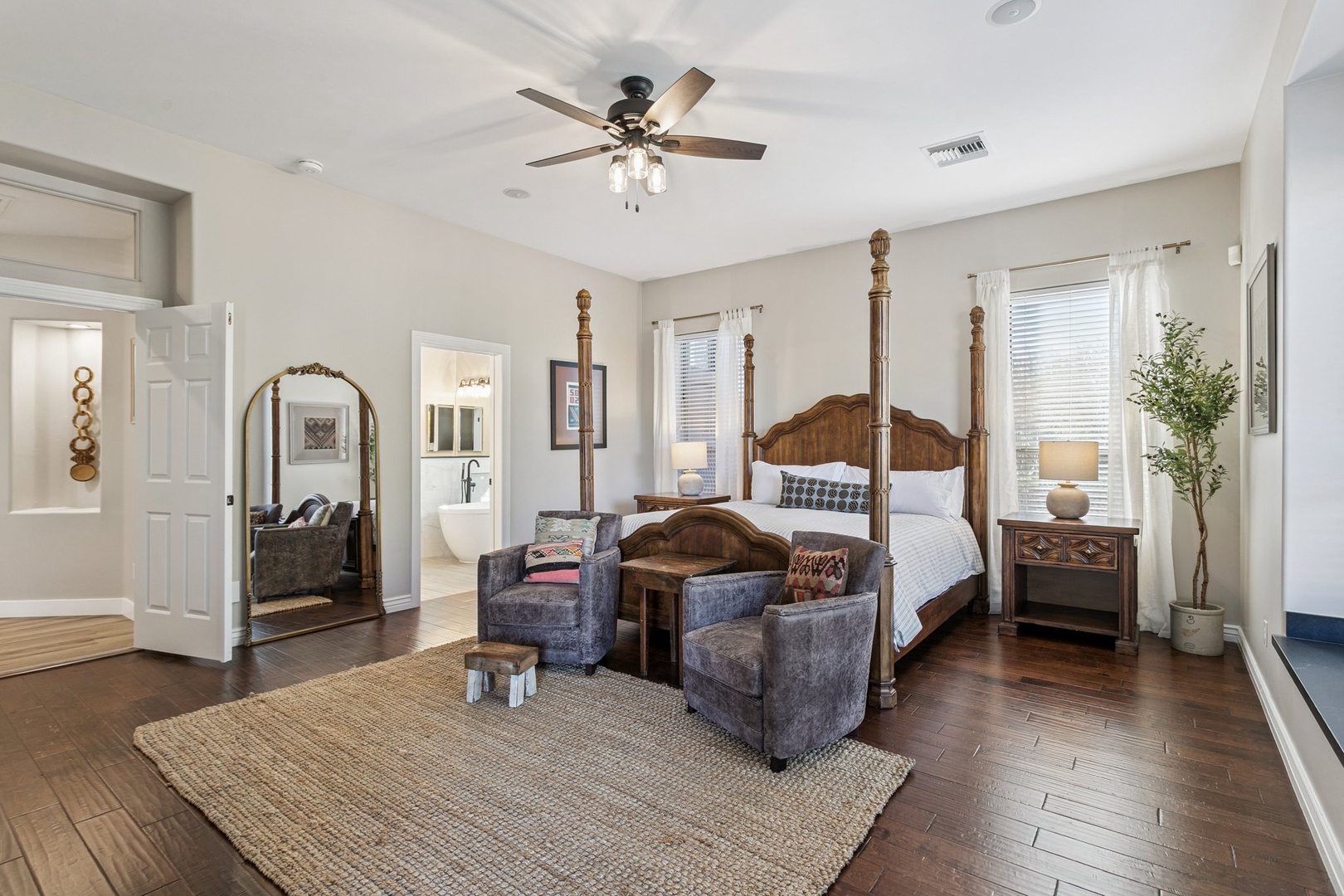 Unwind in your elegant master suite featuring a grand four-poster bed, cozy seating area, and peaceful natural light.