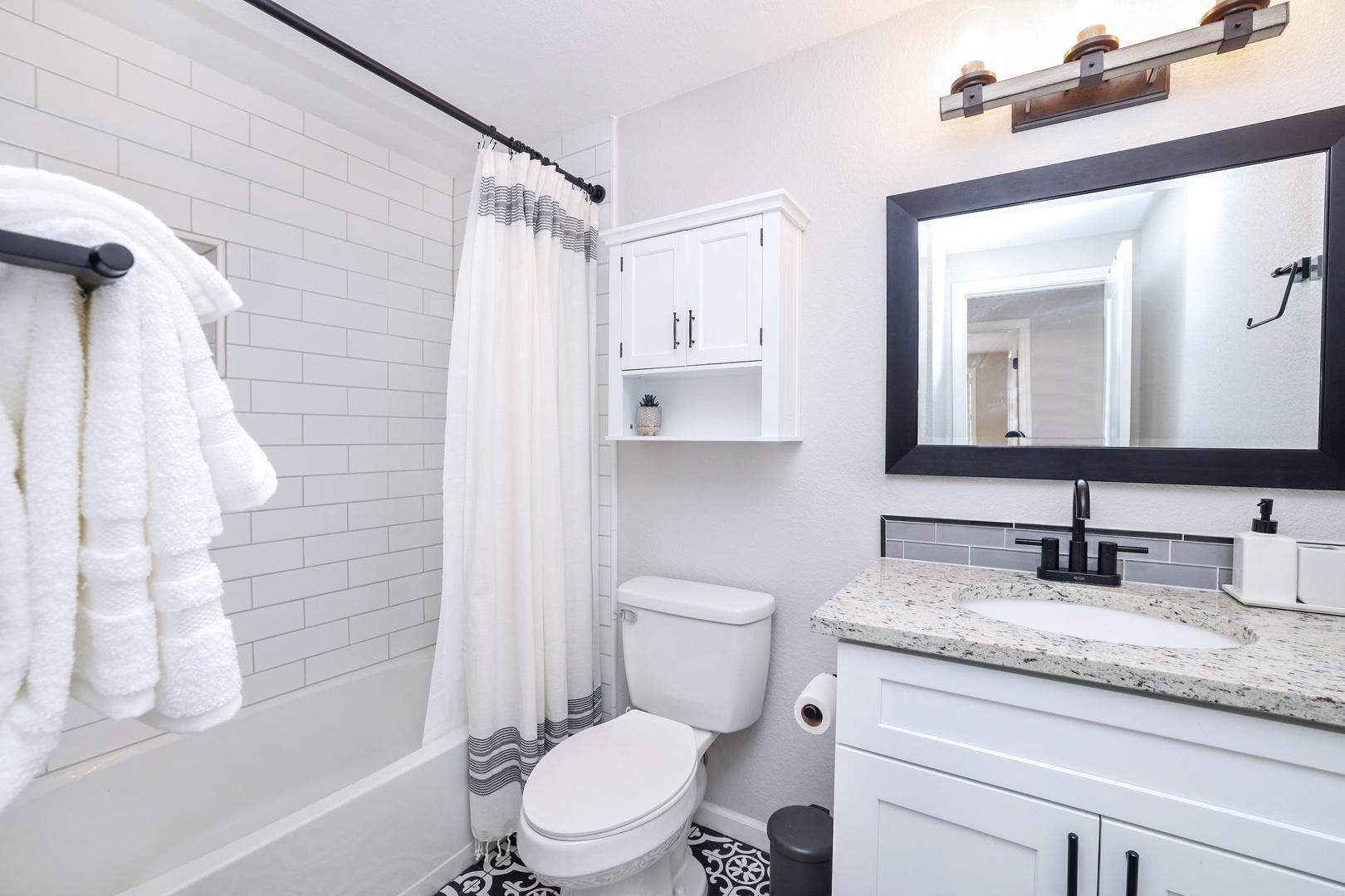 Second bathroom, fully stocked with items including: shampoo, conditioner, body wash, and fresh towels.