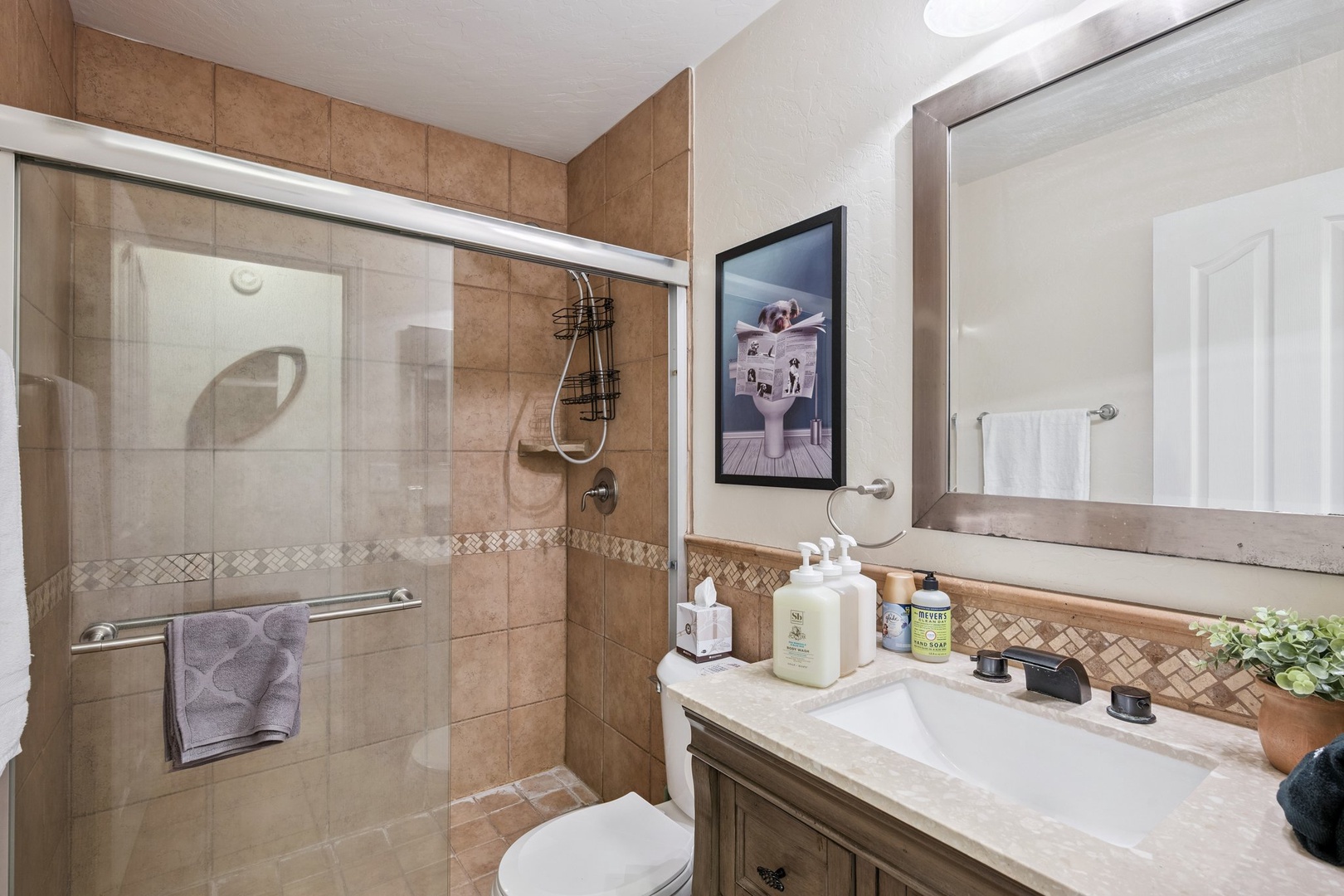 Refresh in your beautifully appointed bathroom with a spacious walk-in shower, elegant tilework, and thoughtful amenities ready for your stay.