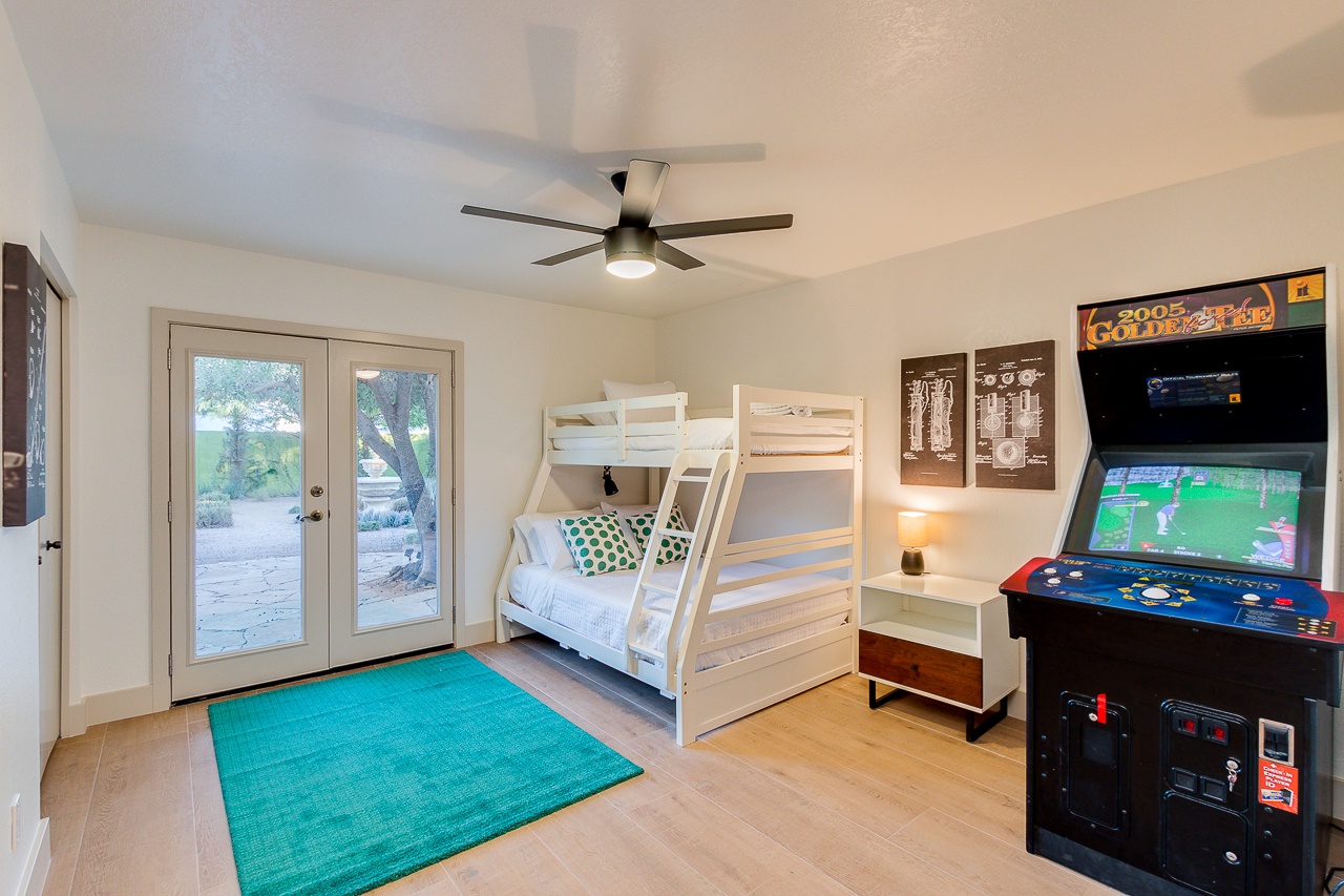 Bedroom 3: One Bunk Bed (single top, double bottom), Two Rollaway beds in closet, and a Full-size Golden Tee arcade game!