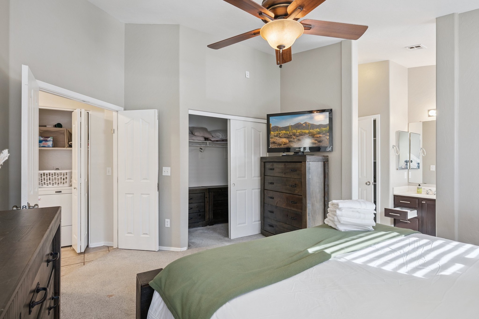 Your spacious bedroom features a cozy ceiling fan, flat-screen TV, and plenty of closet storage for a relaxing stay.
