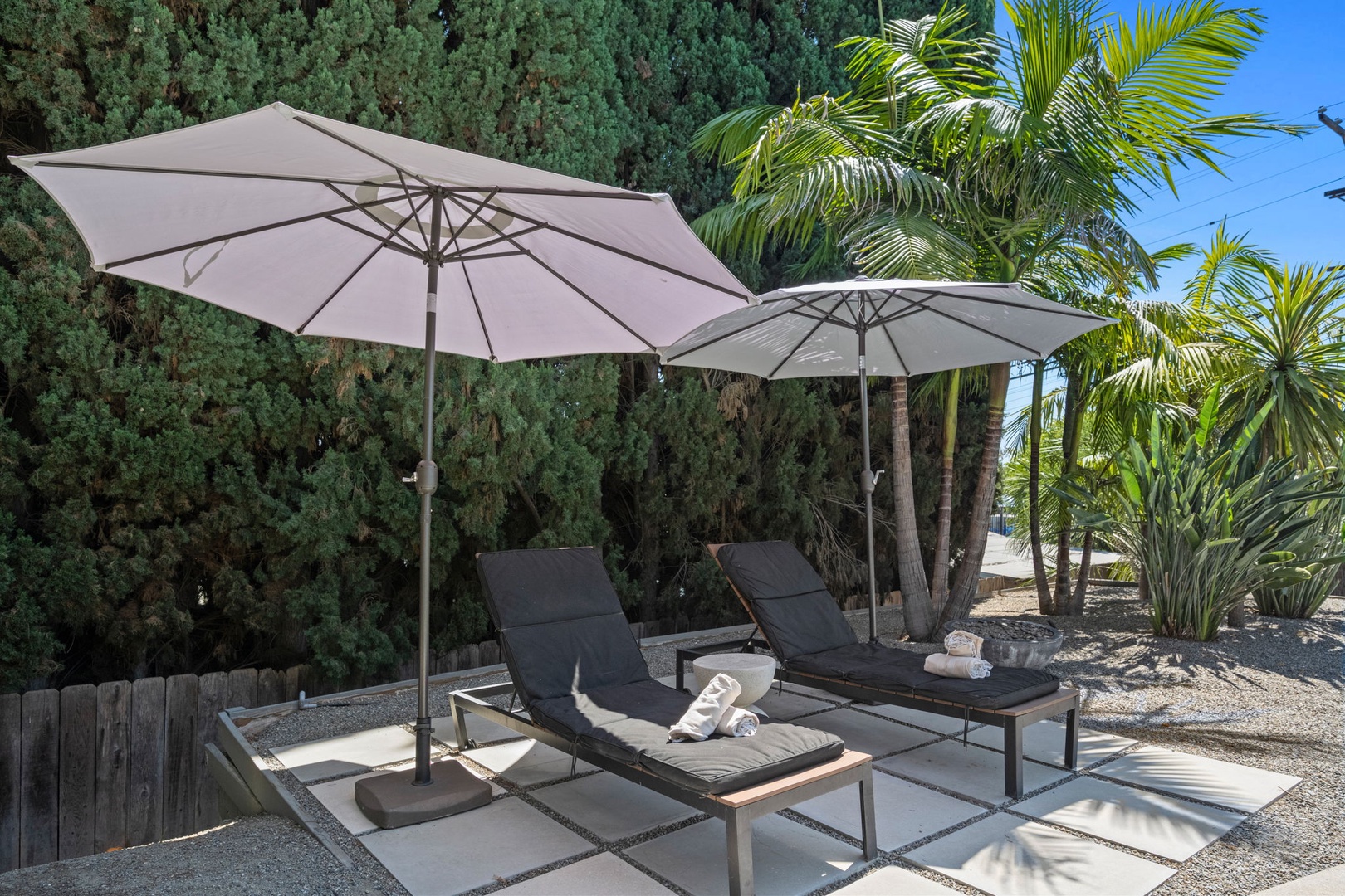 Stretch out on your private sun loungers beneath swaying palms and feel the desert breeze. This secluded outdoor retreat offers shade when you need it and sun-soaked relaxation anytime.