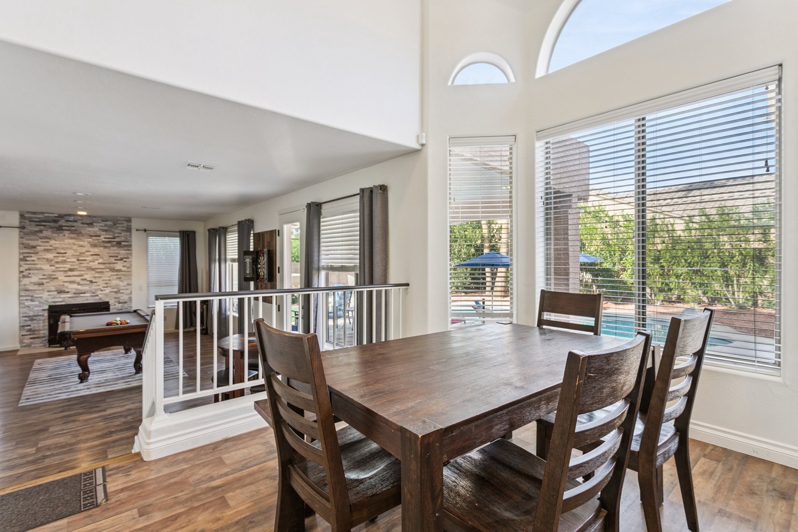 Gather around this beautiful dining table where natural light streams through large windows, creating the perfect spot for your memorable meals together.