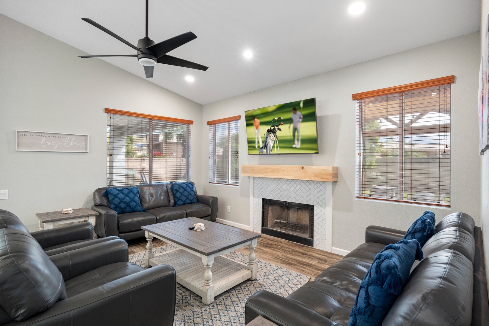 Relax in this inviting family room with plush leather sofas, fireplace, and flat screen tv