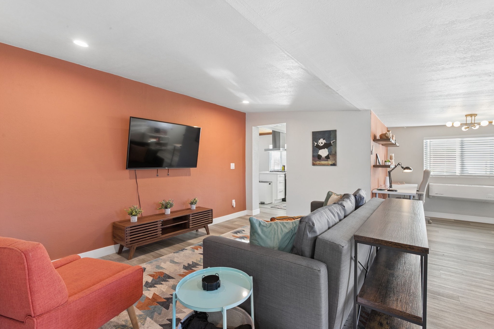 Unwind on your plush gray convertible sofa bed while watching your favorite shows on the wall-mounted TV.