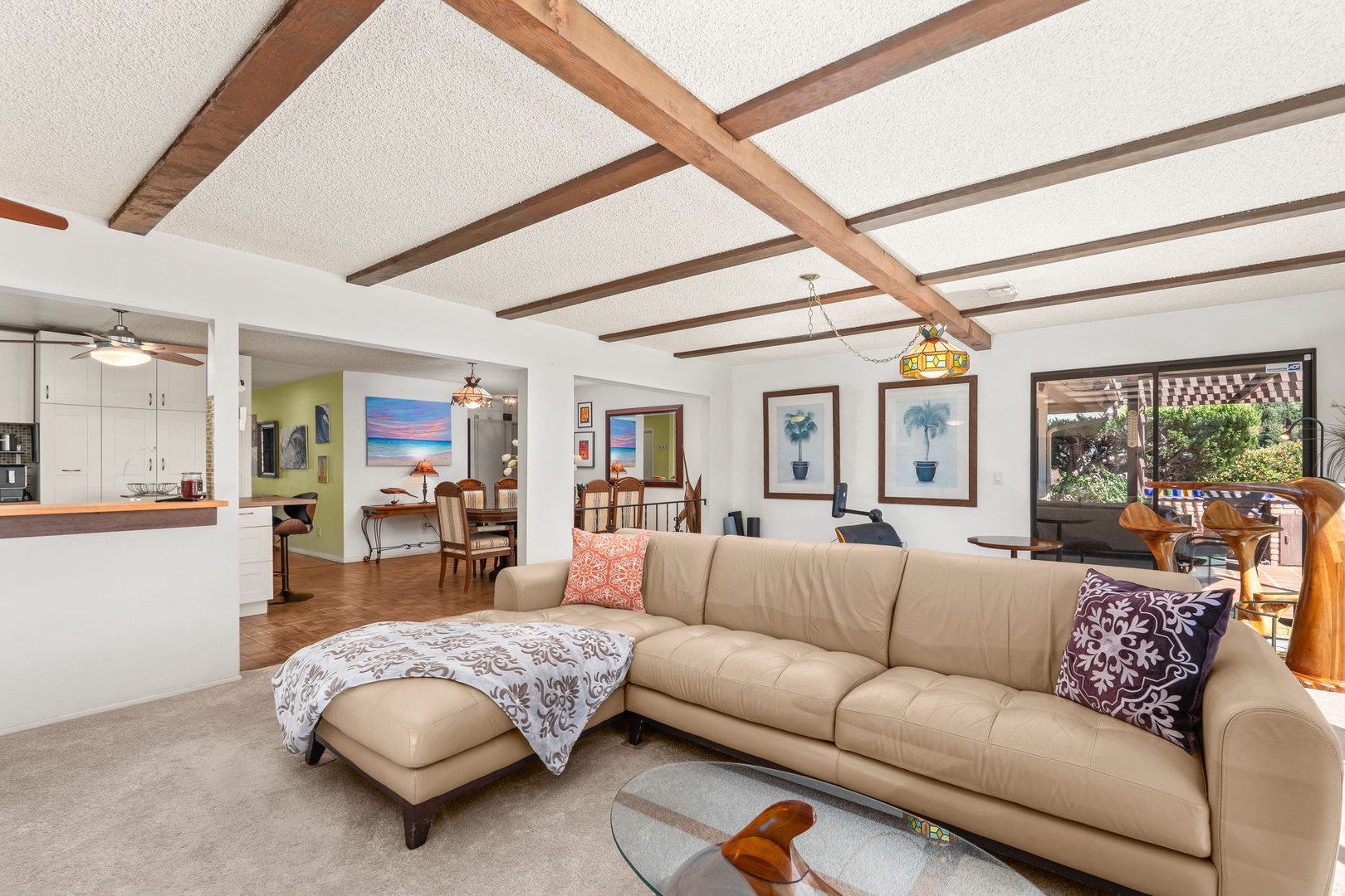 Relax in your spacious open-concept living area with beautiful exposed wooden beams overhead and comfortable furnishings throughout.