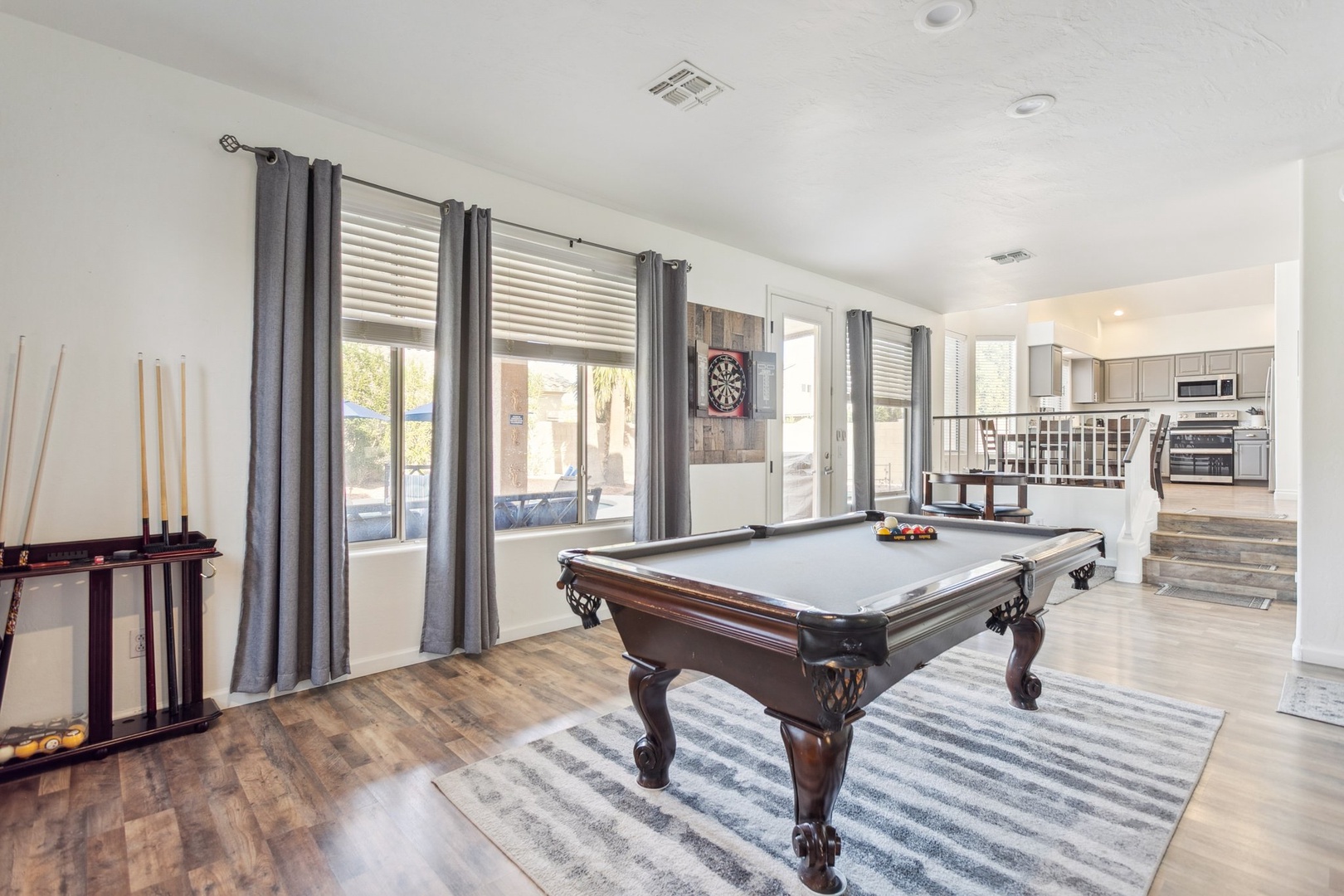 Challenge friends to pool while enjoying this bright game room with dartboard and open kitchen access for snacks.