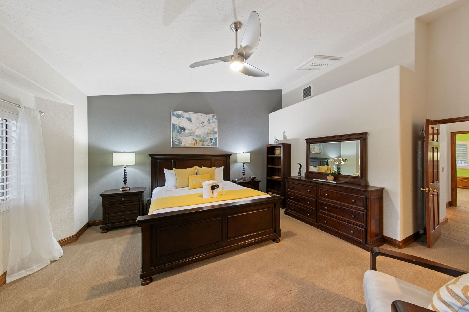 Unwind in your elegant primary suite featuring a plush king bed, cozy seating area, TV, and ensuite bathroom.