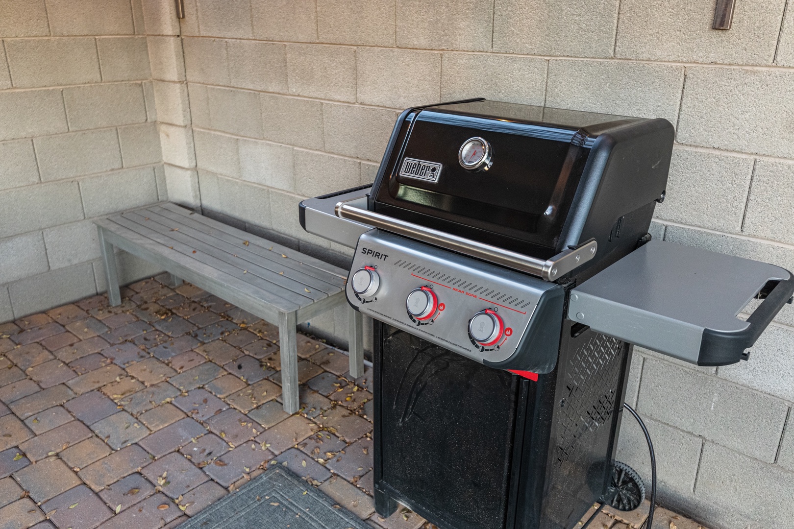 Fire up the Weber grill for your perfect cookout on this charming patio space complete with convenient seating.