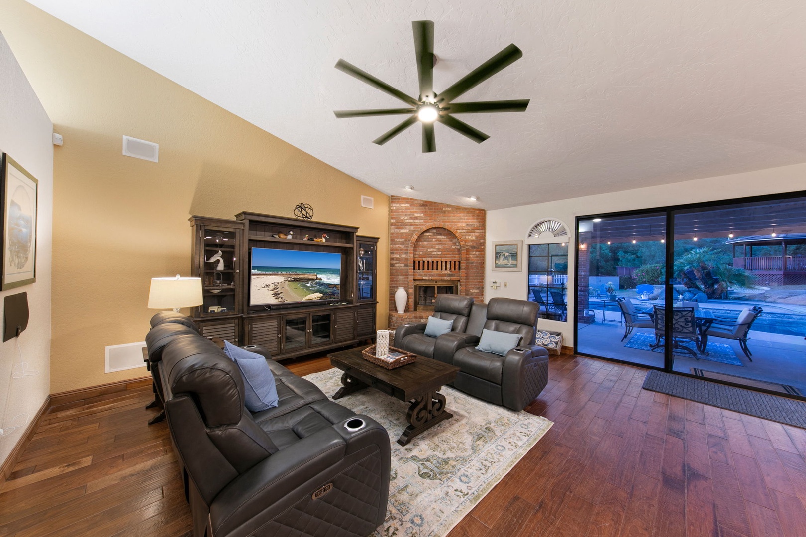 Sink into plush leather recliners while you enjoy movie nights by the warm fireplace and ceiling fan comfort.