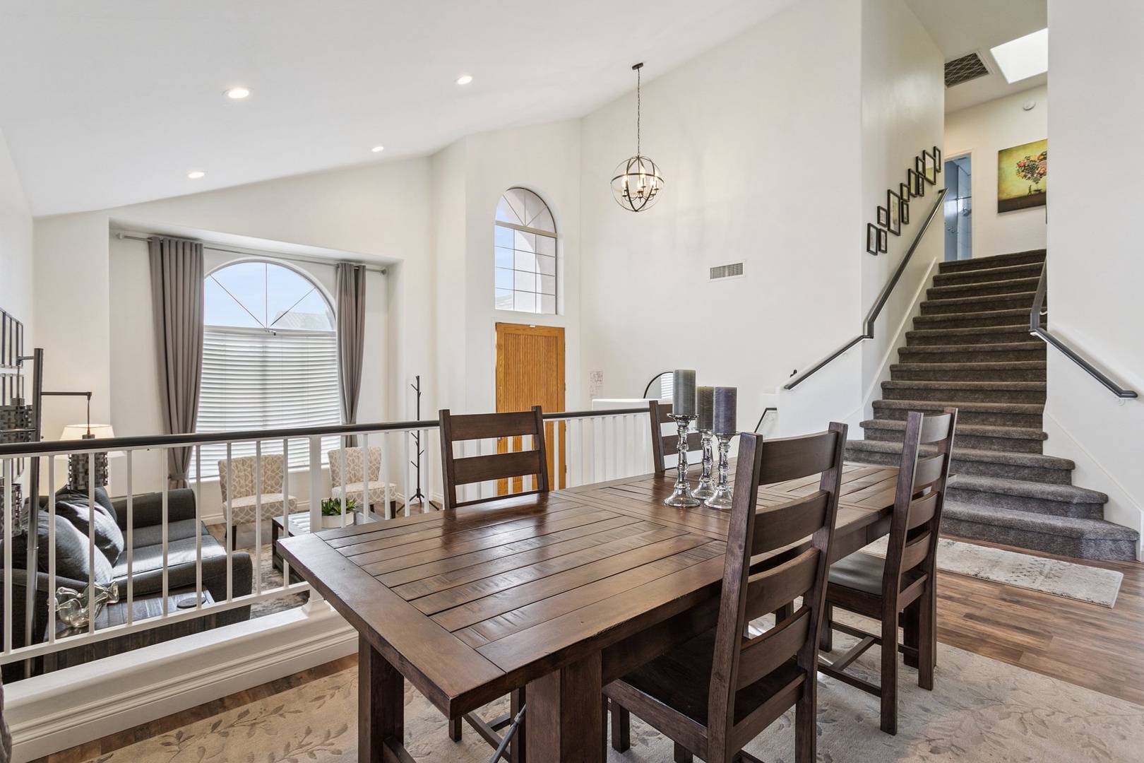 Gather around your elegant dining table in this bright, airy space where warm wood meets modern comfort for memorable meals together.