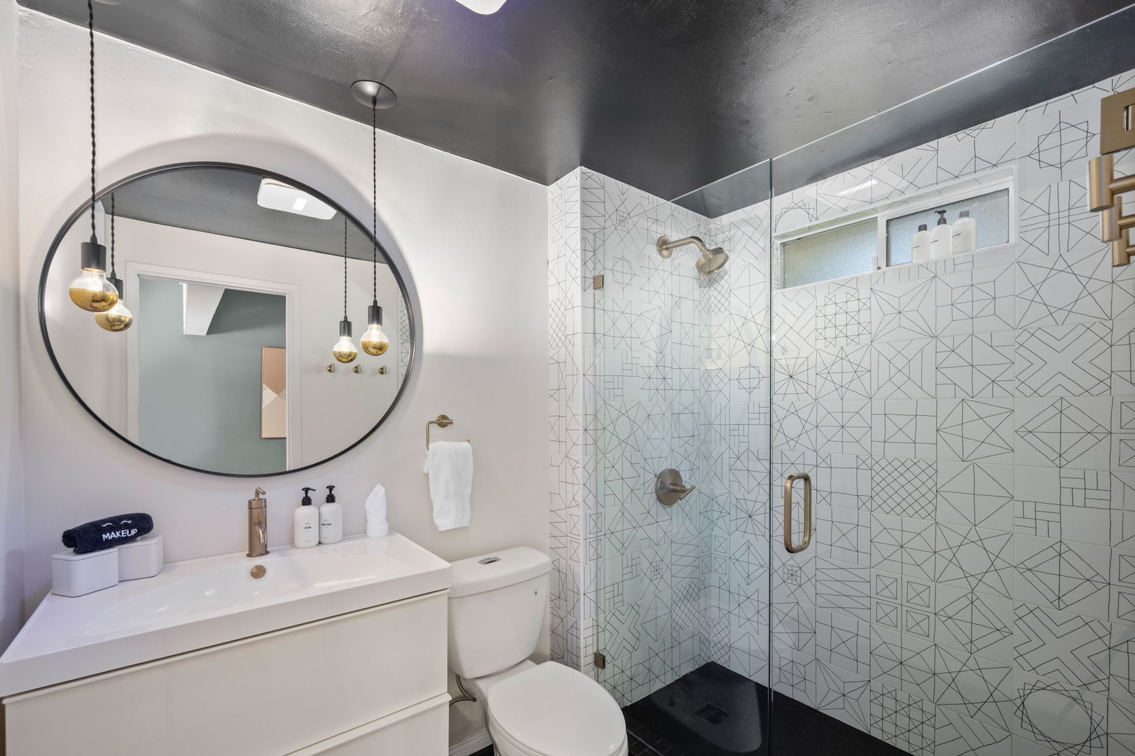 Primary ensuite bathroom with vanity and walk in shower.