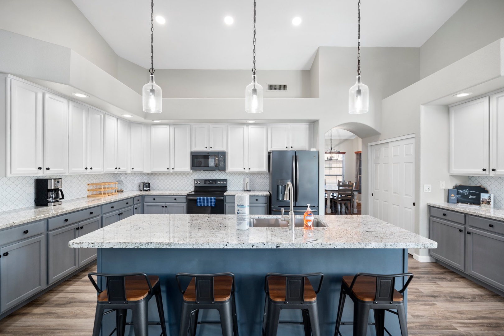 Spacious kitchen with a generous island for meal prep, granite countertops, and modern appliances ready for your culinary adventures.