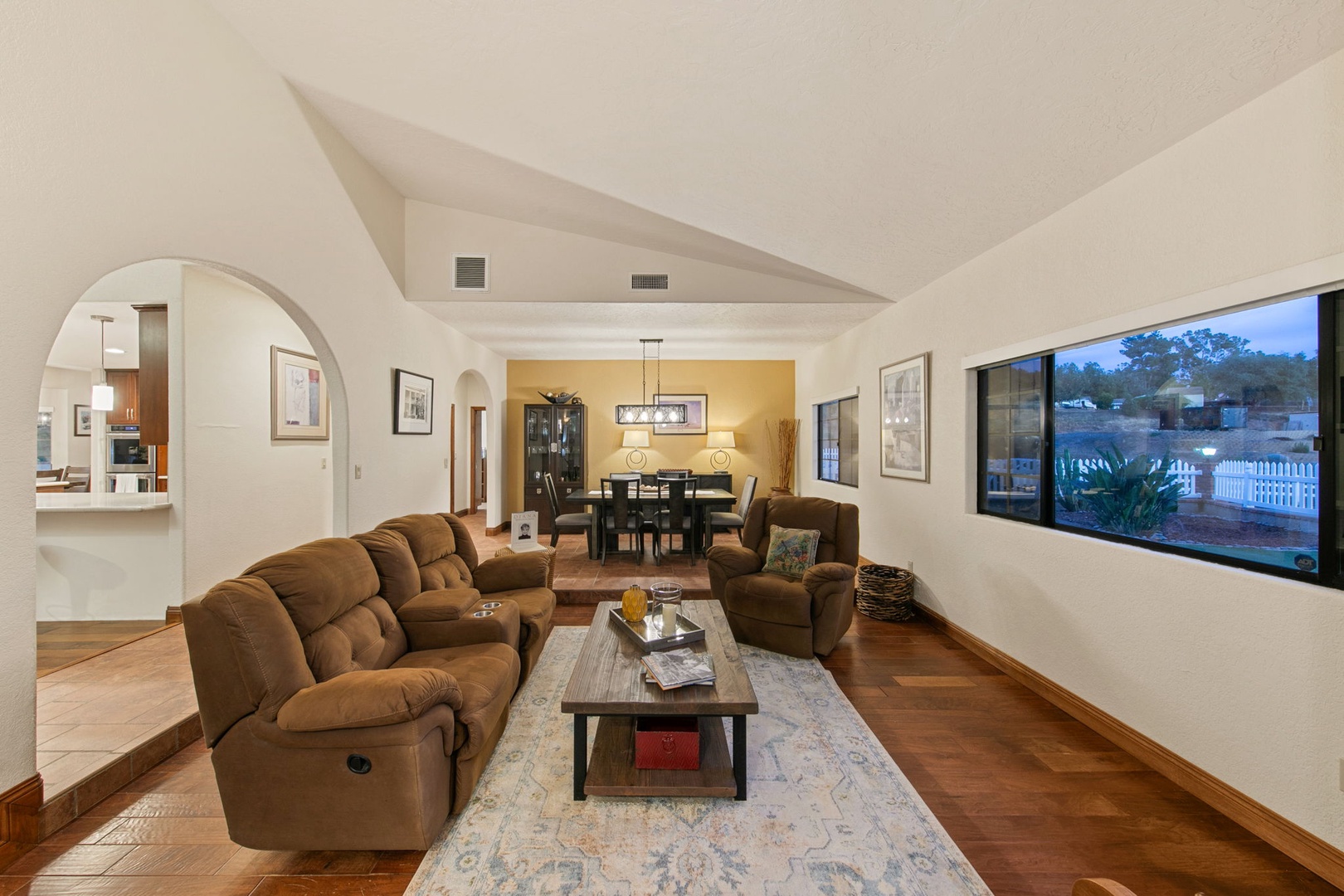 Sink into plush recliners and unwind in your spacious living area with soaring ceilings and warm wood floors.