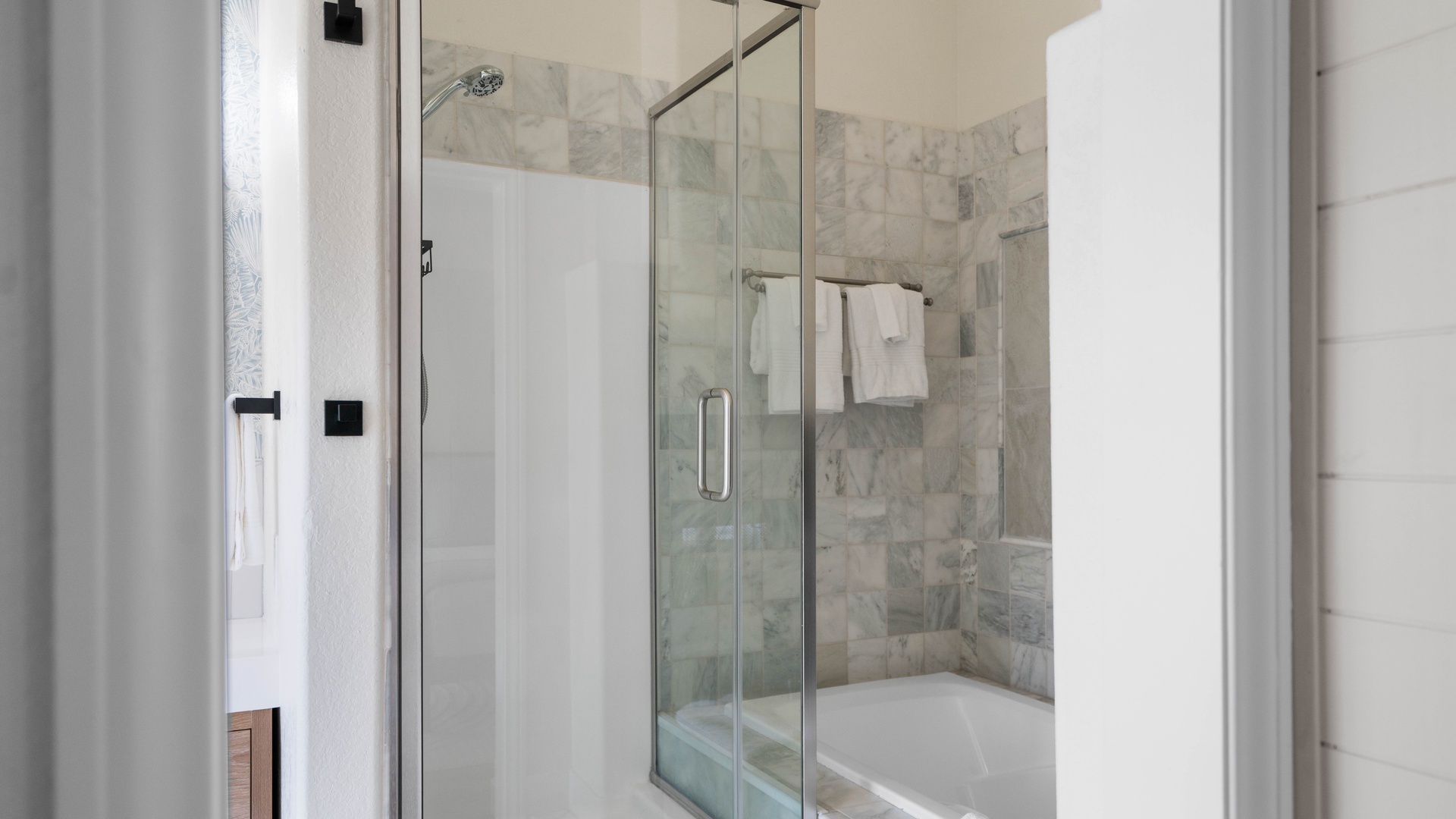 Primary Bedroom ensuite bathroom featuring a walk-in shower and soaking tub with see through fireplace