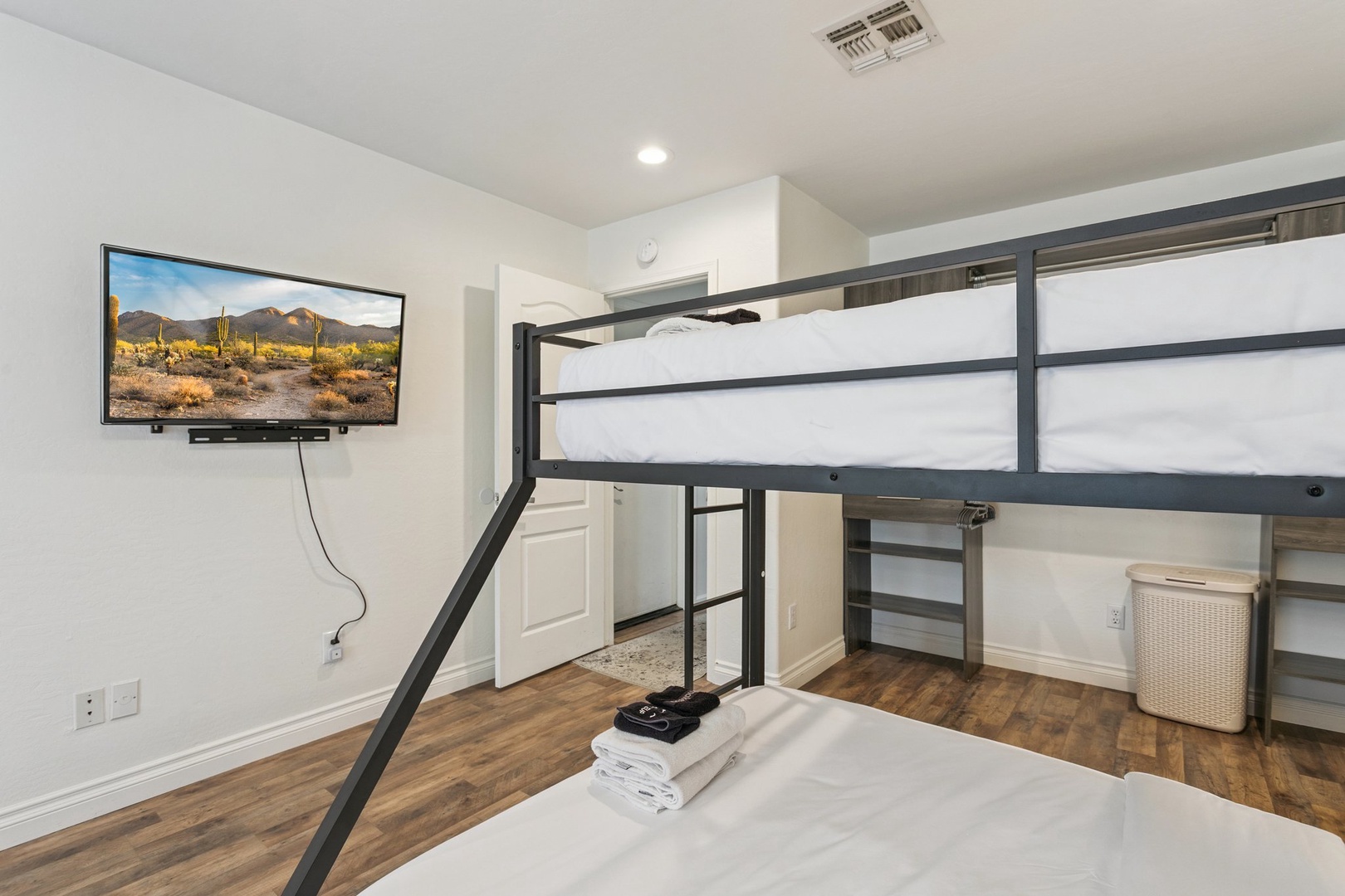 Your modern bunk room features crisp linens, entertainment, and thoughtful touches like fresh towels waiting for your arrival.