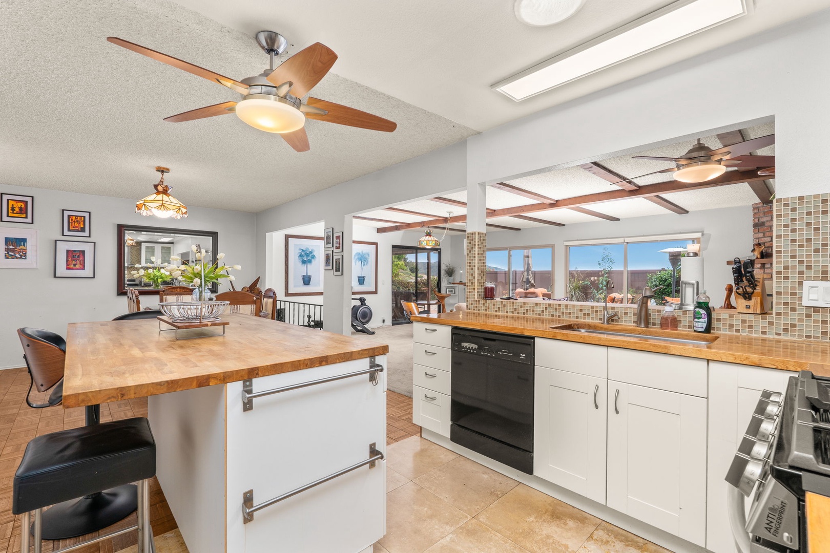 Your gourmet kitchen awaits with spacious countertops, modern appliances, and warm wood accents perfect for creating memorable meals together.