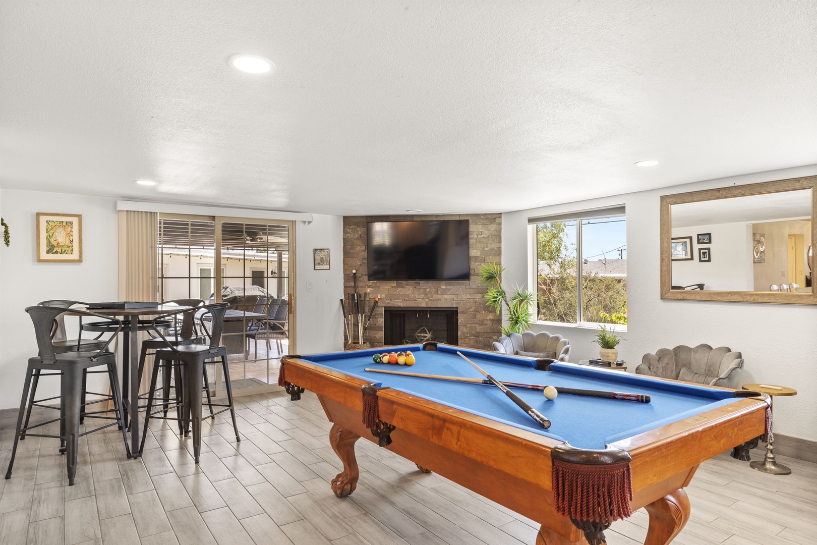 Game room with pool table and additional living area.