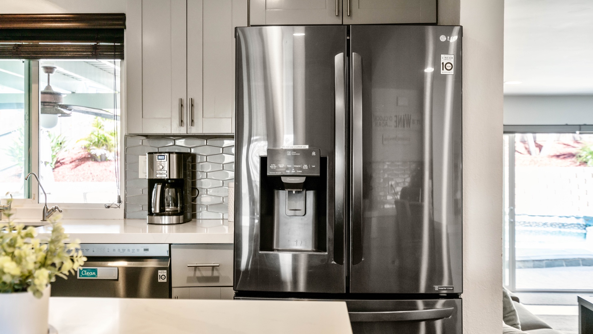 Large kitchen with stainless steel appliances.