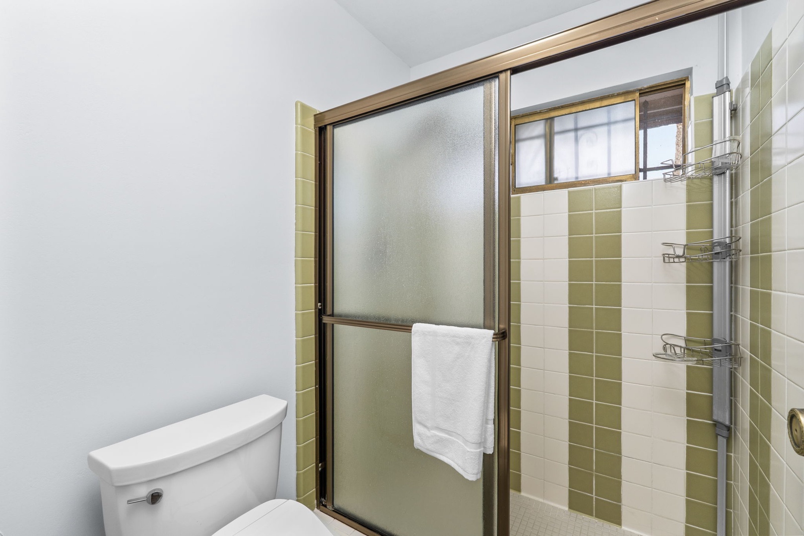 Step into your private bathroom featuring a spacious walk-in shower with fresh towels and thoughtful amenities ready for your comfort.