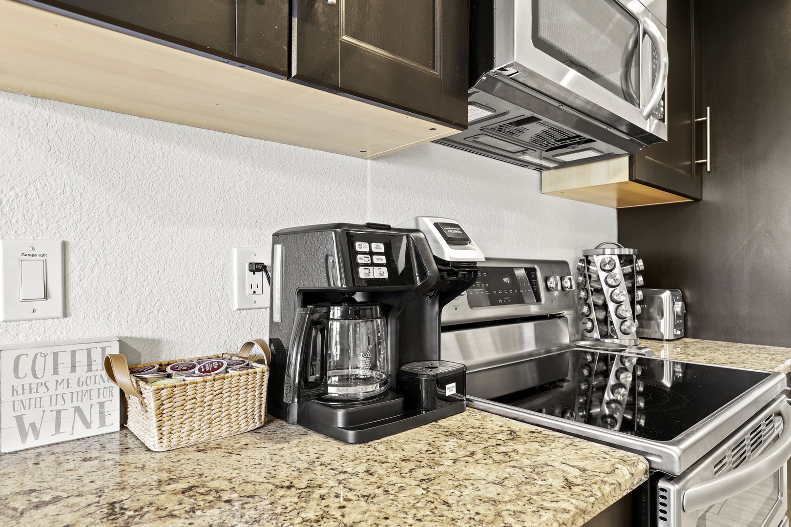 Modern kitchen outfitted with stainless steel appliances and everything you need to cook up all your favorites - Pots, Pans, Utensils, Spice Rack, Toaster, Kettle, Blender, Drip Coffee Maker, Filtered Water, Ice Maker.