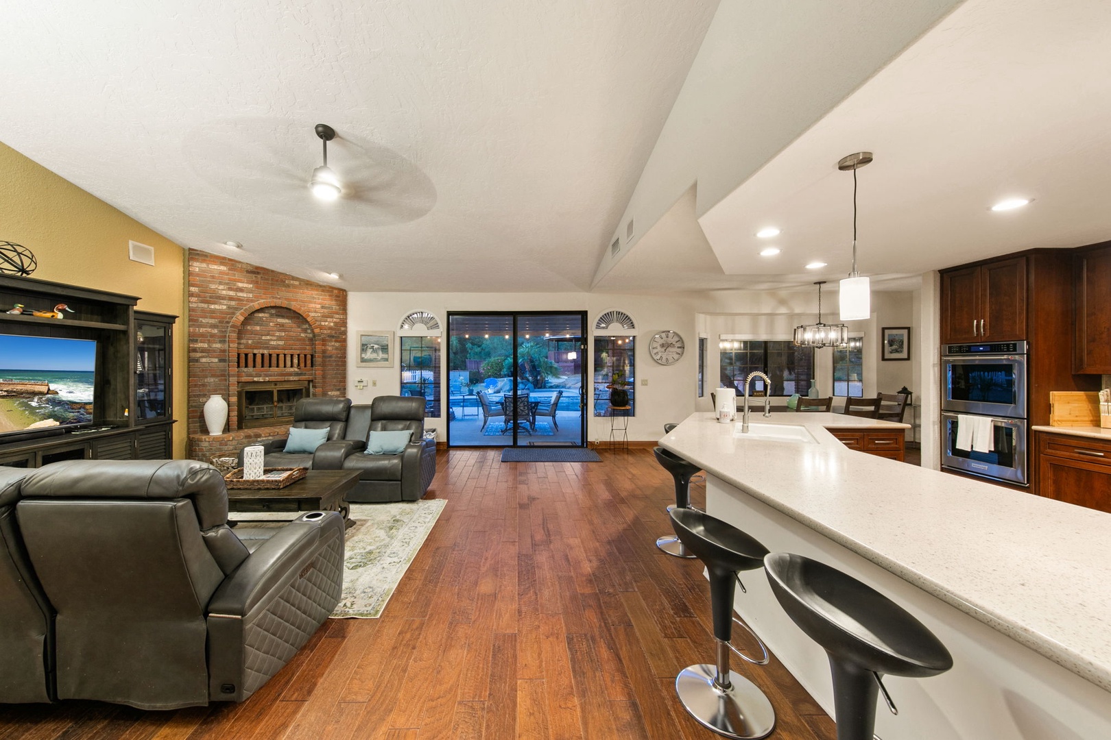 Spacious open-plan living combines your gourmet kitchen, cozy lounge, and elegant dining area with gleaming hardwood floors throughout.