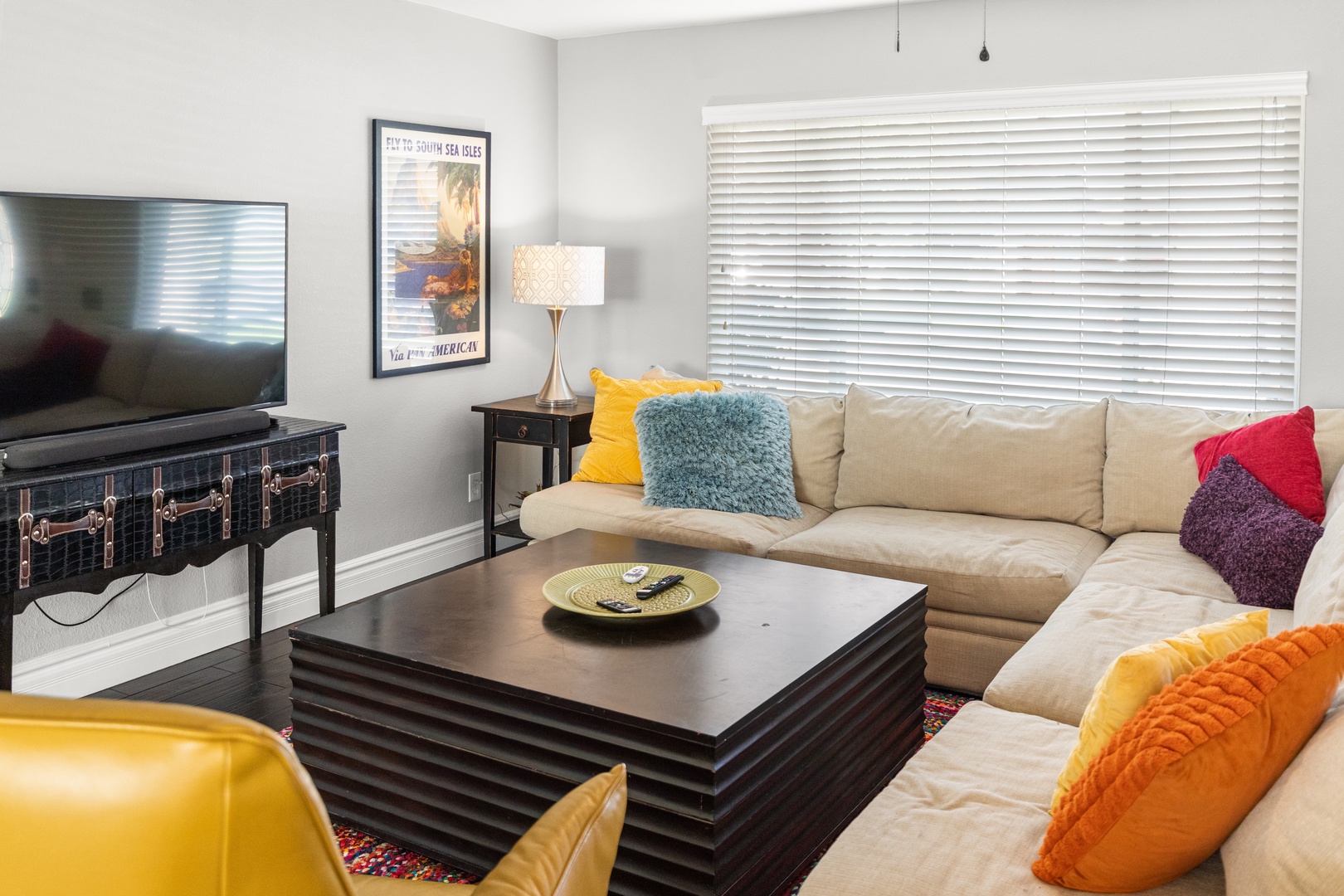 Sink into this cozy living room where colorful pillows accent plush seating, perfect for unwinding after your adventures.