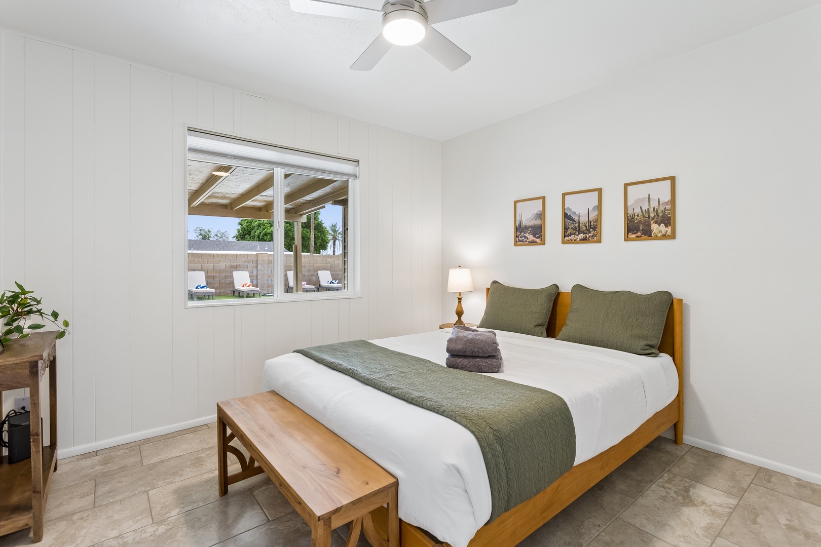 Rest easy in this bright bedroom where crisp linens and calming earth tones invite you to unwind. The covered patio just outside your window promises leisurely mornings and peaceful evenings under the desert sky.