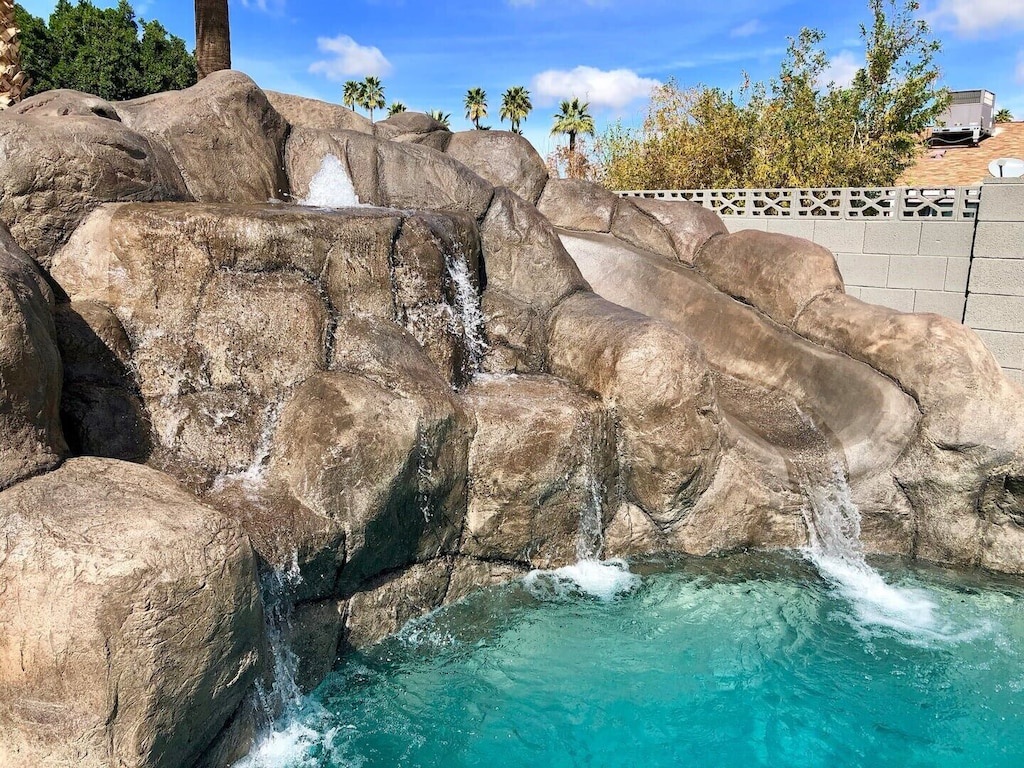 Sparkling pool with 3 waterfalls, a slide, and a huge hot tub