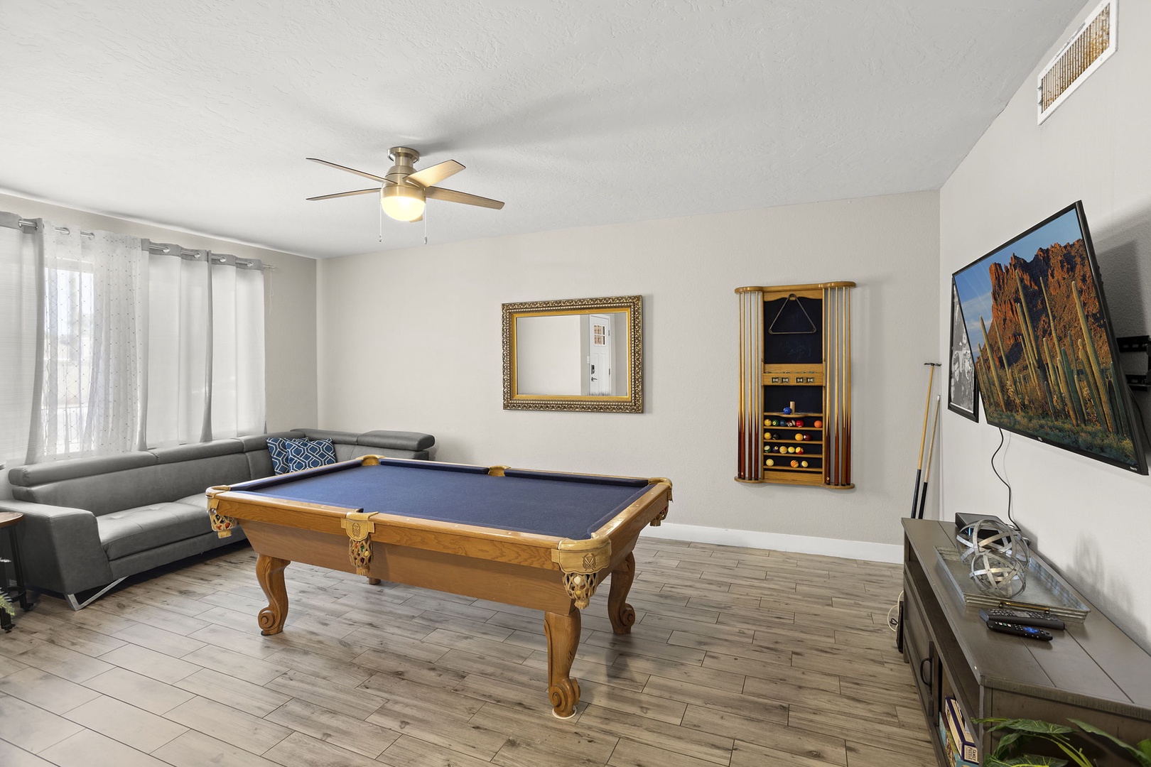 Lounge includes a pool table, flat screen tv, sofa, and high top tables.