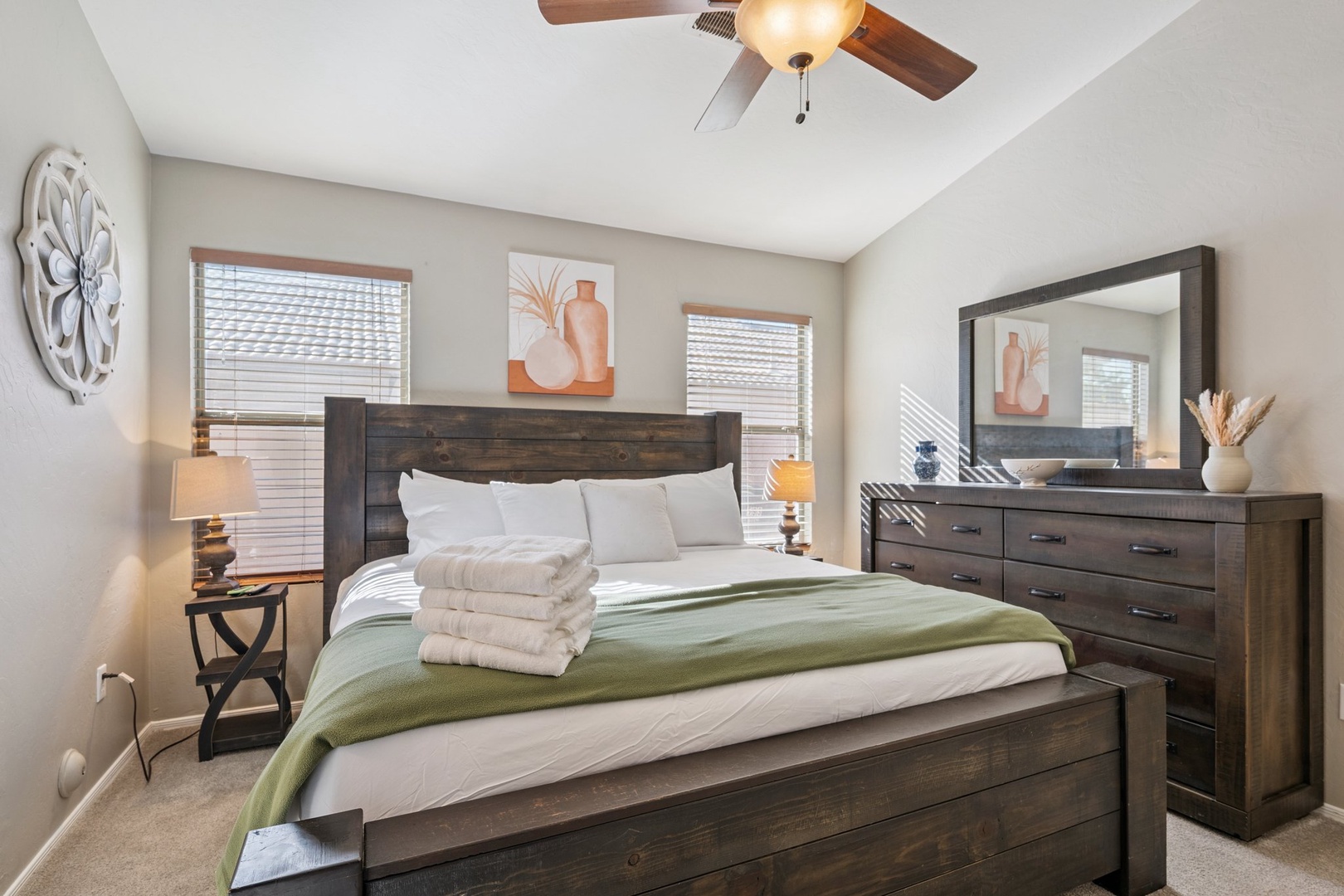 Sink into crisp white linens and unwind in your serene bedroom retreat, complete with rustic wood furnishings and thoughtful amenities.