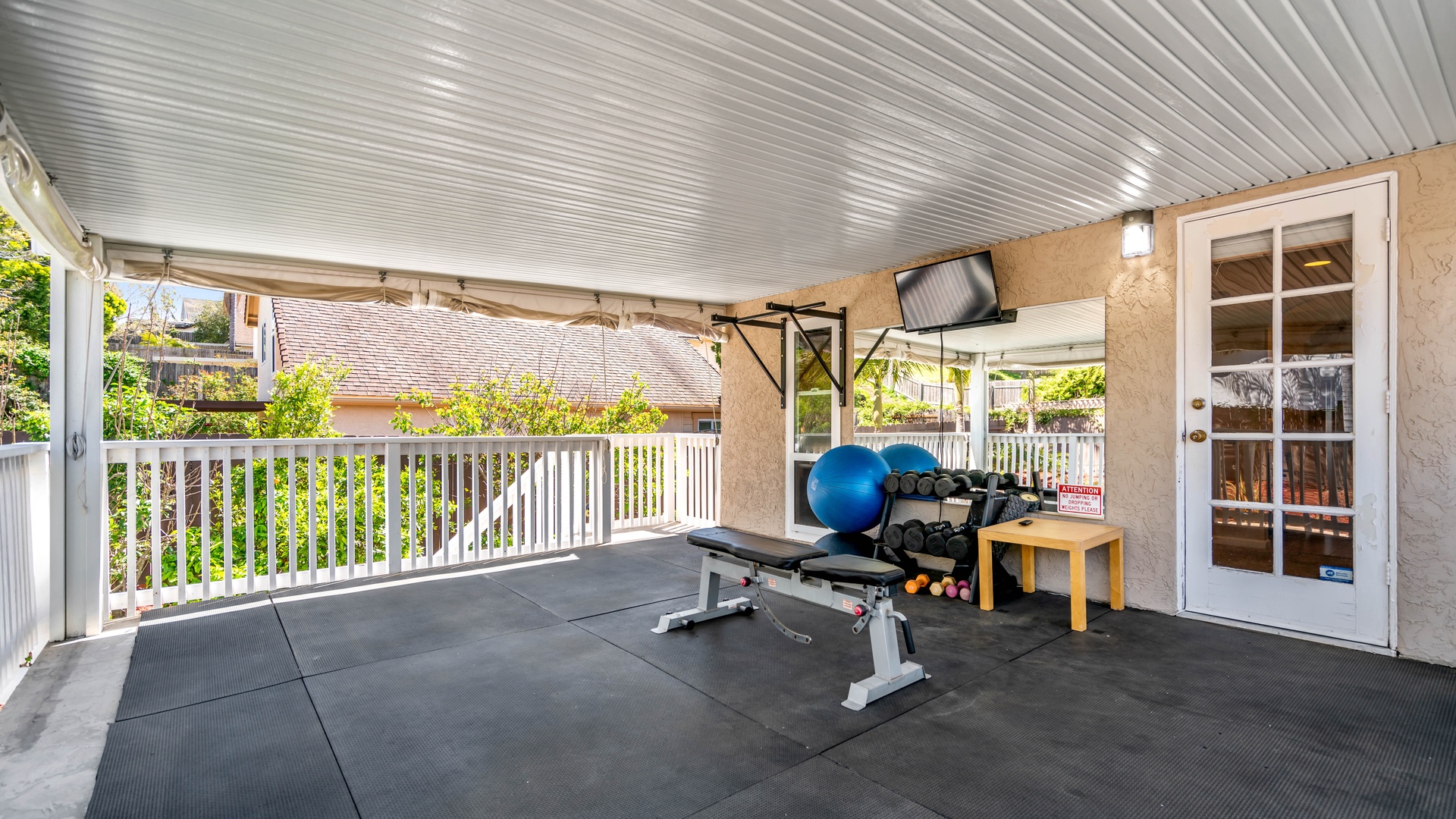 Get your workout in at the fully functional outdoor covered gym with dumbbell set, and wall-mounted pull-up bar. TV and plenty of space for functional training.