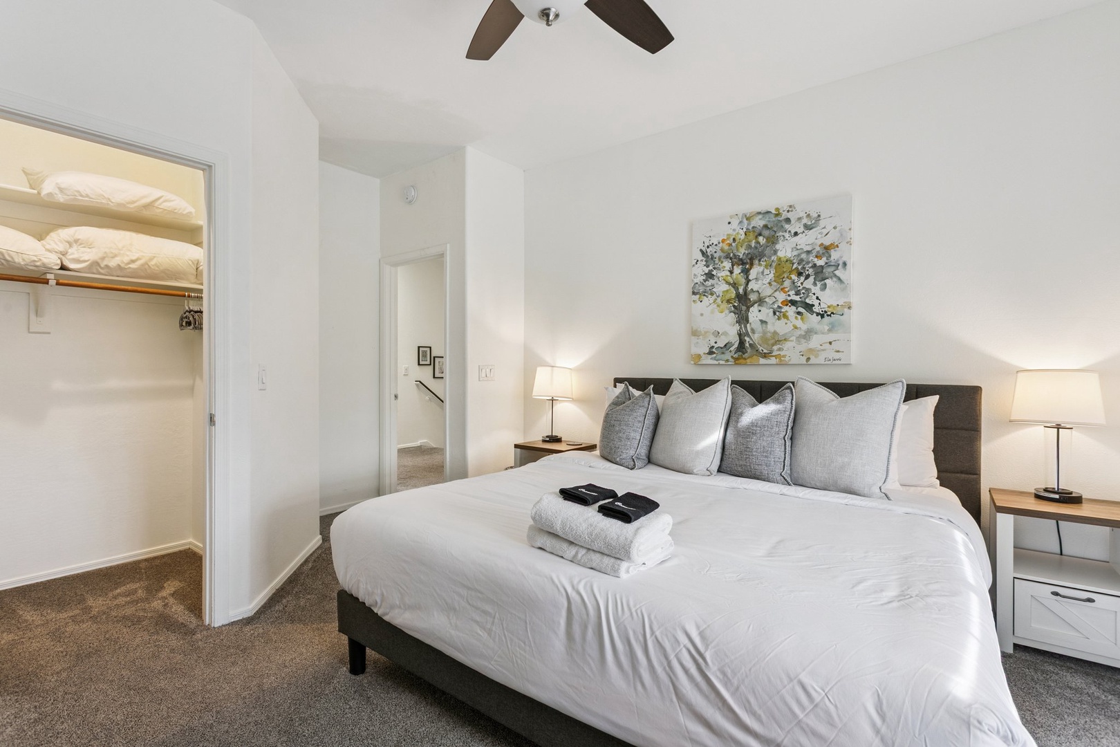 Settle into your peaceful bedroom featuring a plush king bed with fresh linens and soft lighting creating the perfect retreat.