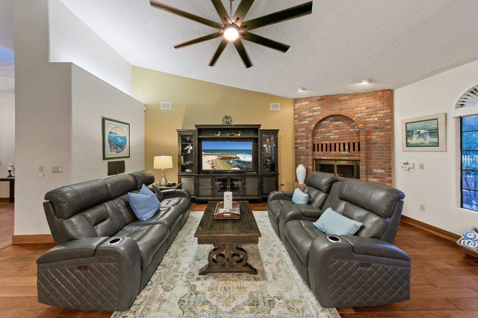 Settle into plush leather recliners in your spacious living room, where the warm fireplace and large TV create the perfect spot for cozy evenings together.