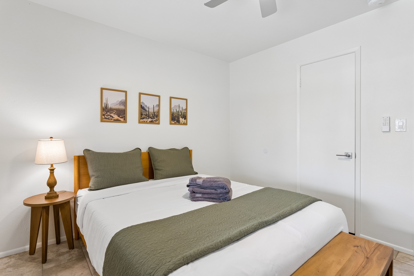 Sink into crisp linens and plush pillows in your serene bedroom, where soft lighting and calming desert art help you unwind completely after a day of adventure.