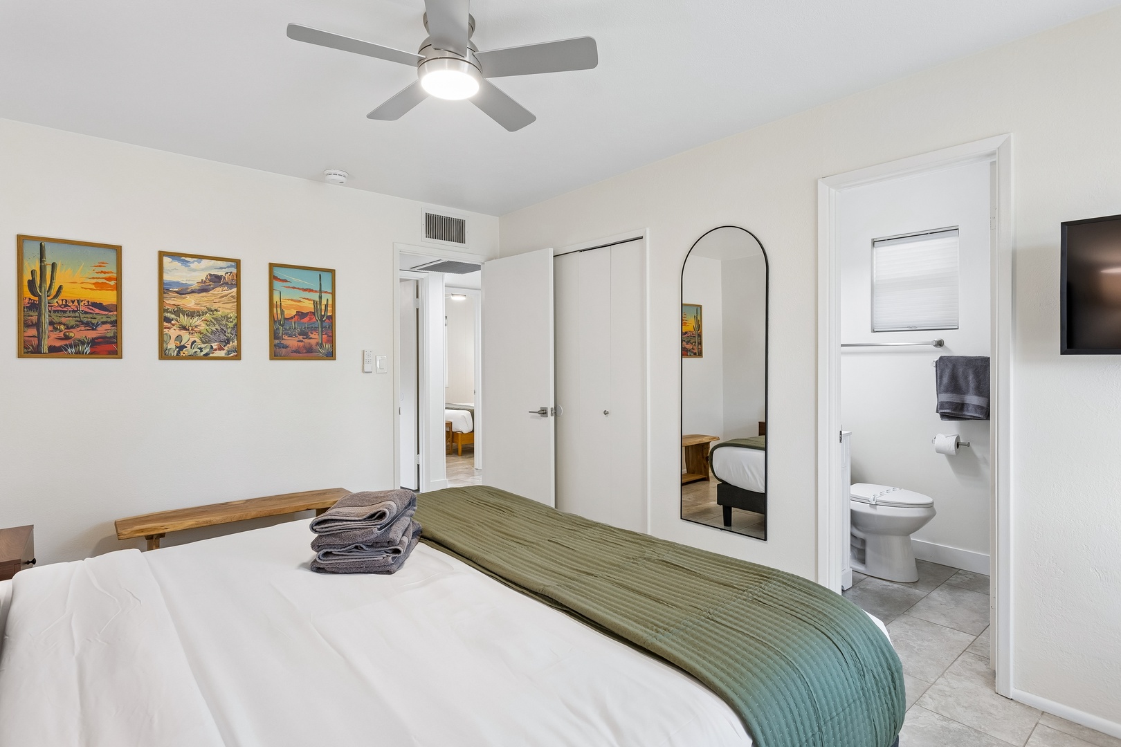 Sink into a serene bedroom designed for restful nights. Your inviting bed, ceiling fan, and en-suite bathroom create a private retreat where relaxation comes naturally.