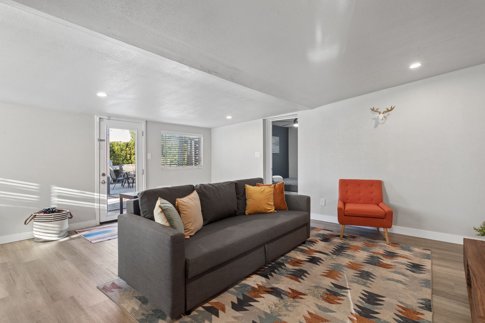 Unwind on your plush gray convertible sofa bed while watching your favorite shows on the wall-mounted TV.