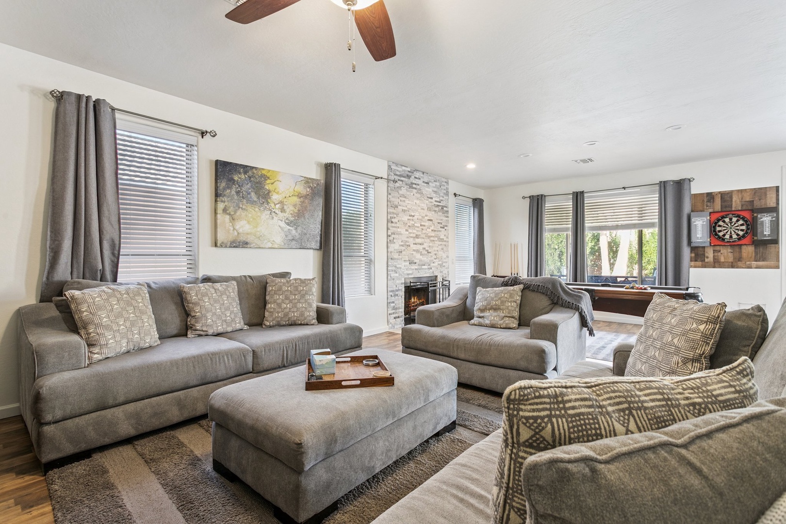 Sink into plush gray sofas and unwind in your spacious living room, complete with a cozy fireplace and entertainment area for perfect evenings in.