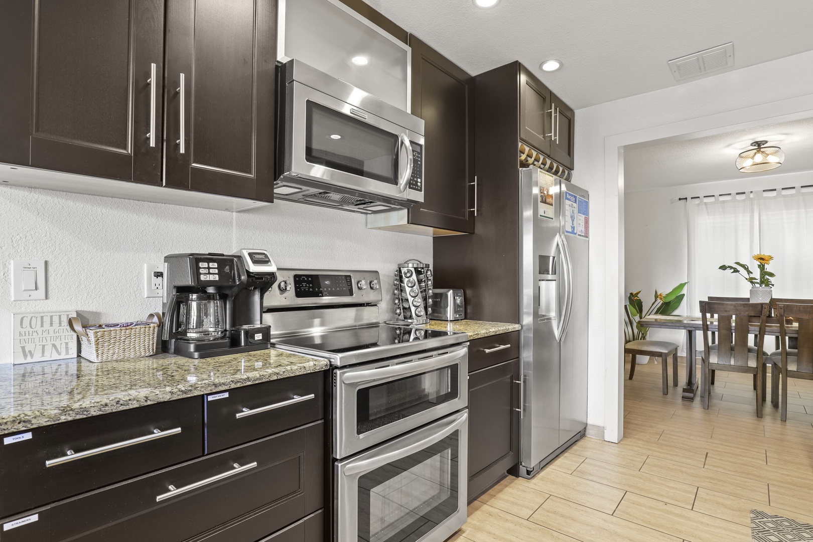 Modern kitchen outfitted with stainless steel appliances and everything you need to cook up all your favorites - Pots, Pans, Utensils, Spice Rack, Toaster, Kettle, Blender, Drip Coffee Maker, Filtered Water, Ice Maker.