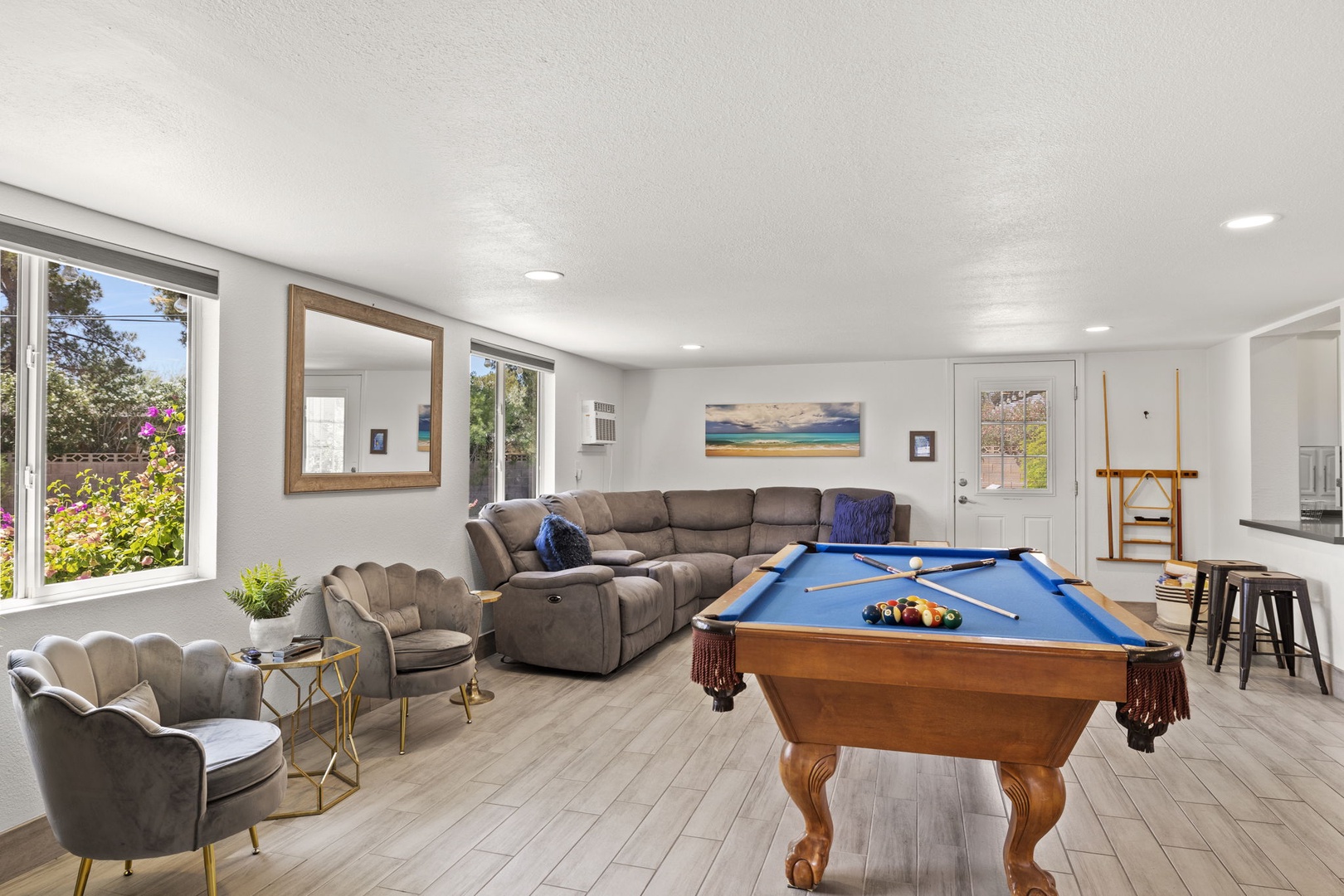 Game room with pool table and additional living area.