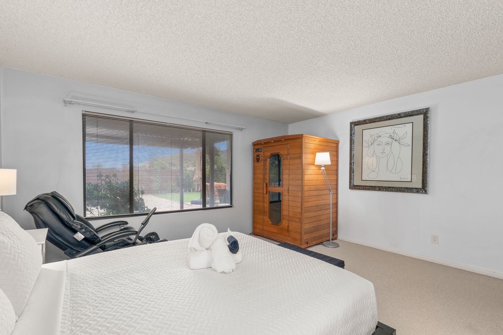 Unwind in your private bedroom featuring a personal sauna and massage chair for ultimate relaxation.