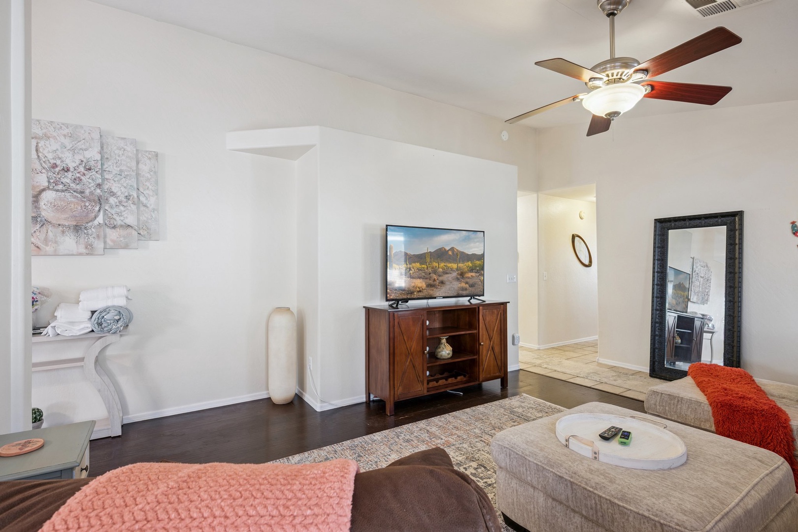 Your comfortable living room invites relaxation with cozy seating, ceiling fan, and entertainment center for memorable evenings together.