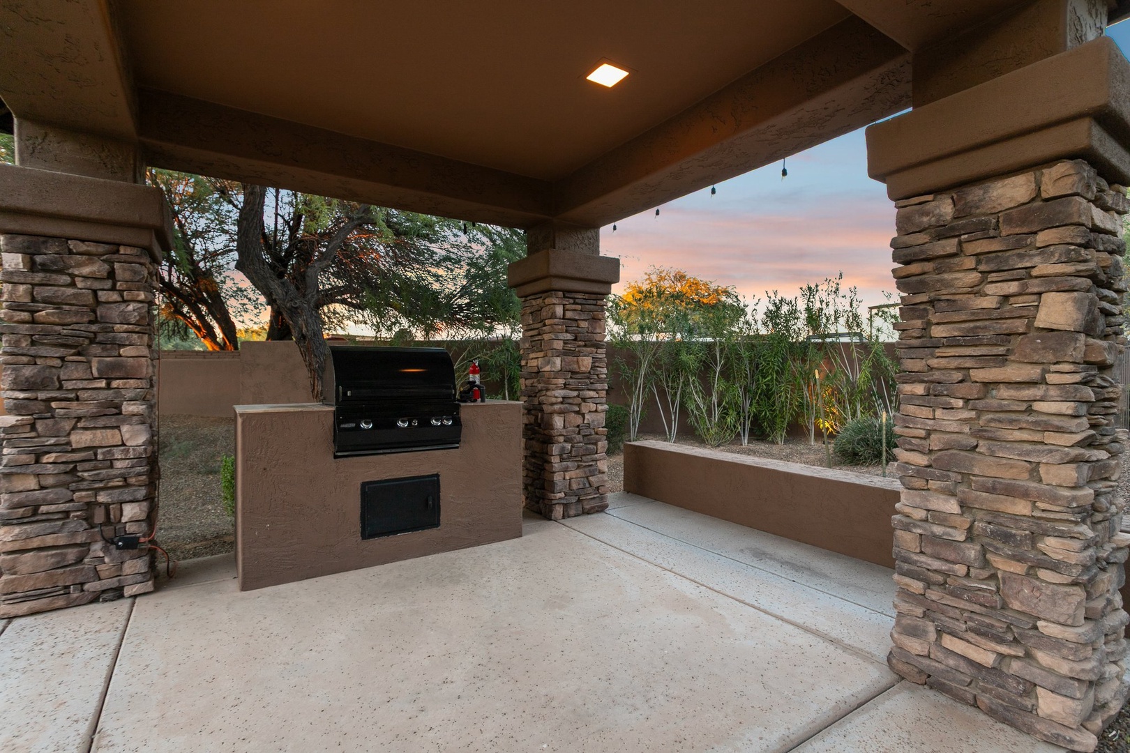 Your private outdoor kitchen awaits with a built-in grill, perfect for evening barbecues under the desert sky.