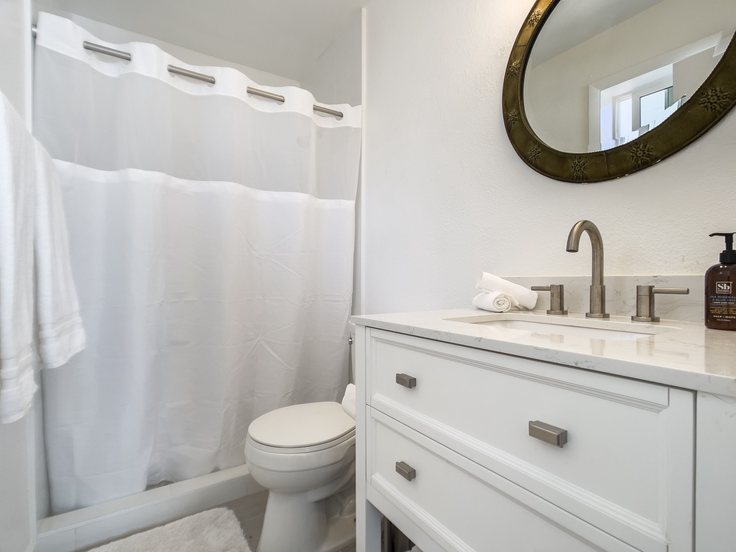 Bathroom 1 : stocked with items including: shampoo, conditioner, body wash, and fresh towels