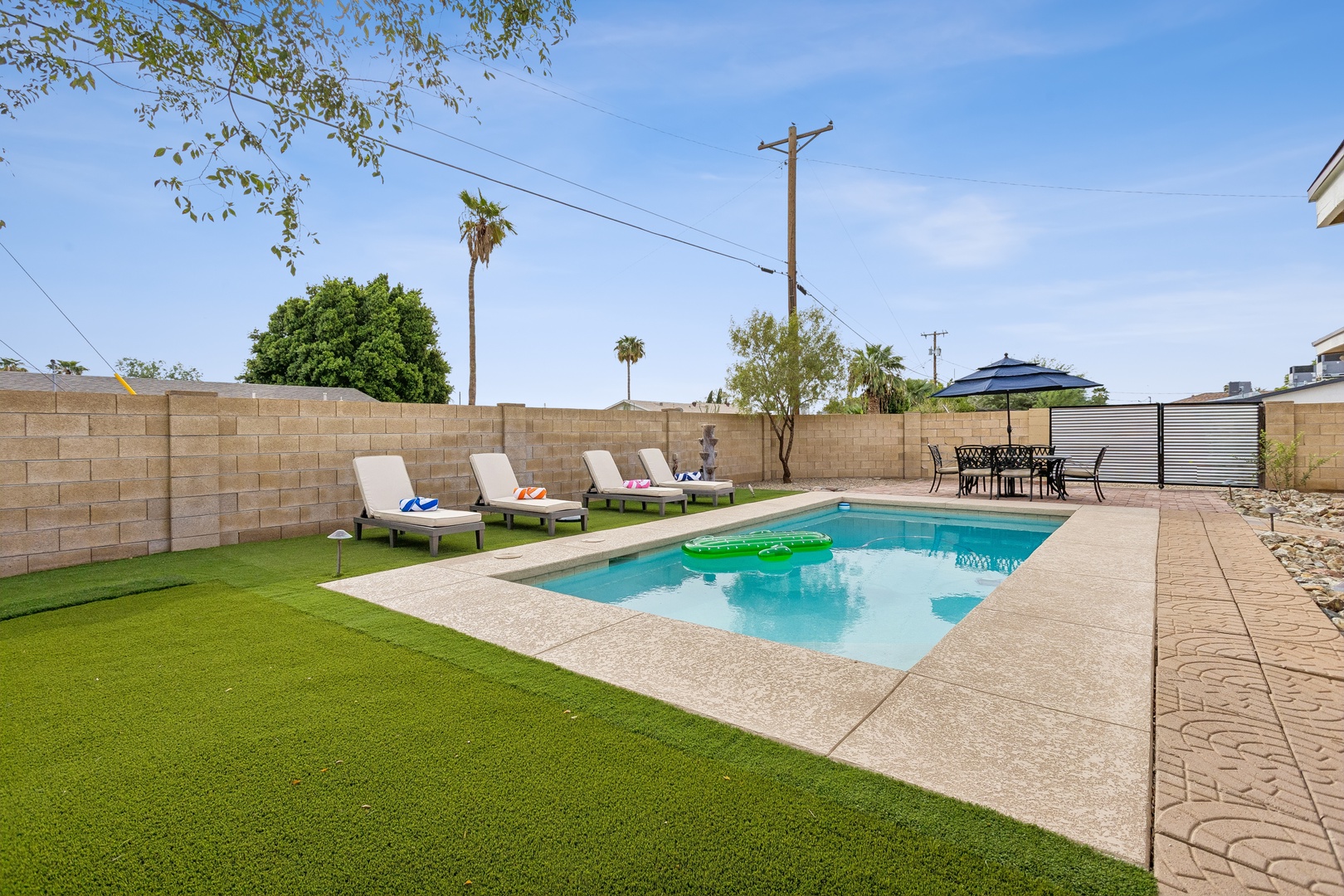 Dive into your private oasis with a sparkling pool, lounge chairs for sunbathing, and a shaded patio dining area—perfect for lazy afternoons and sunset barbecues.