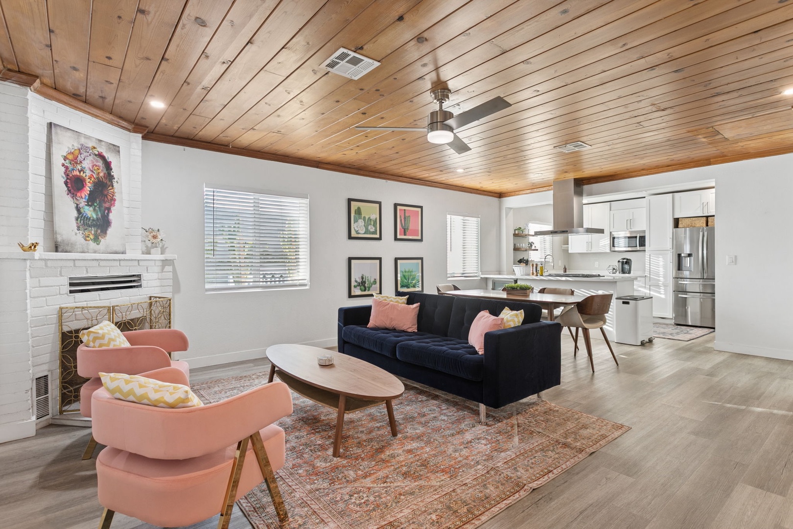 Unwind in your stylish open-concept space featuring warm wood ceilings and thoughtfully curated furnishings that blend modern comfort with artistic flair.