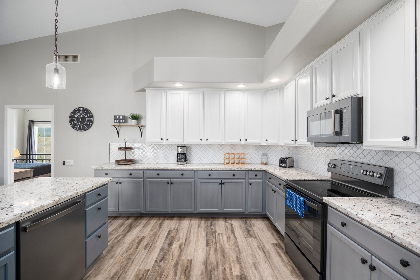 Your spacious gourmet kitchen awaits with gleaming granite counters, ample cabinet storage, and modern appliances—perfect for preparing meals and gathering together during your stay.