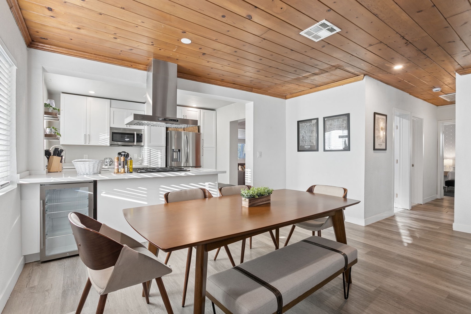 Gather around this stunning dining table under your warm wood ceiling—perfect for sharing meals and making memories together.
