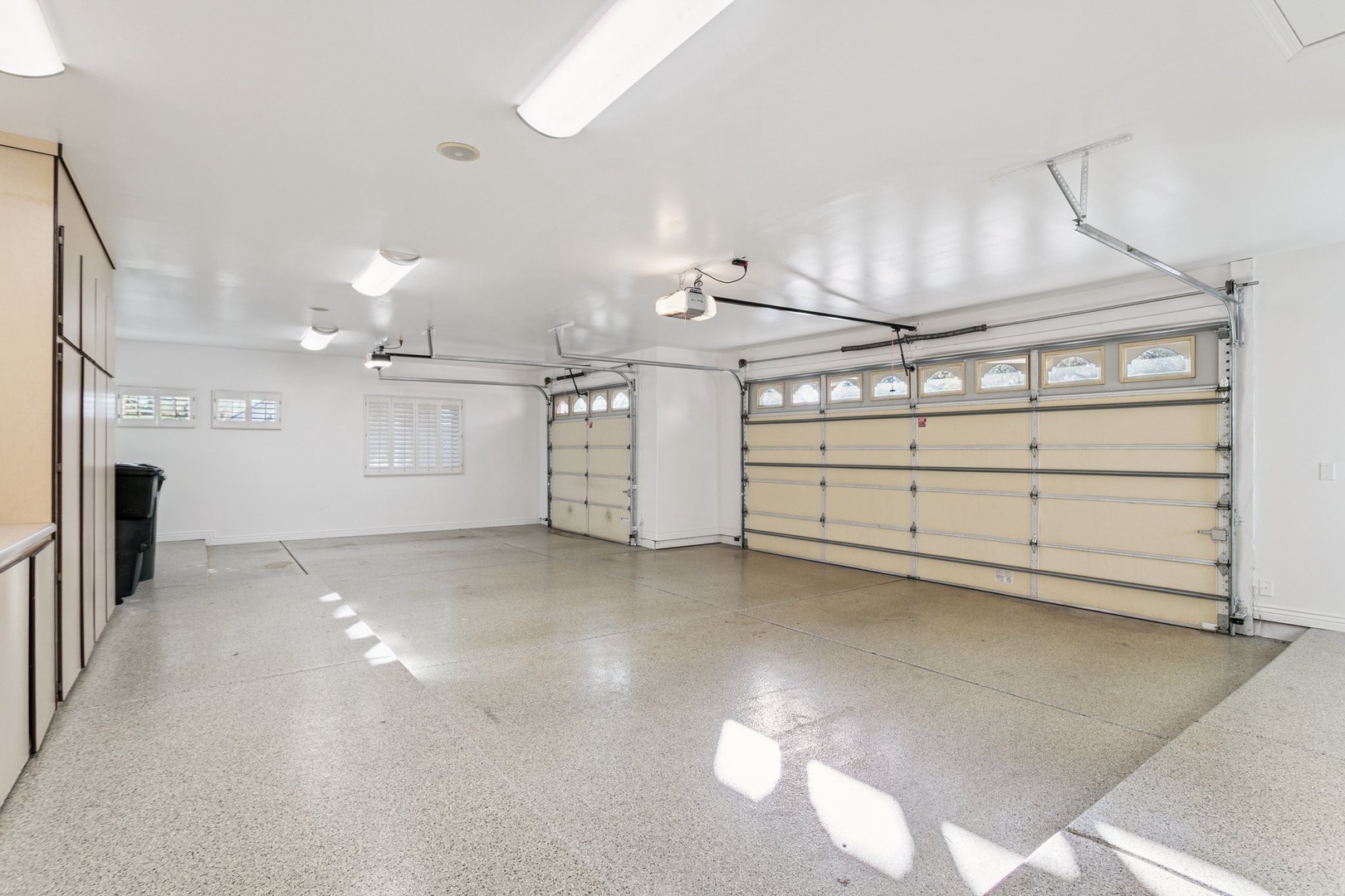 Spacious garage with gleaming epoxy floors and ample storage - your rental includes secure parking and room for all your vacation gear.